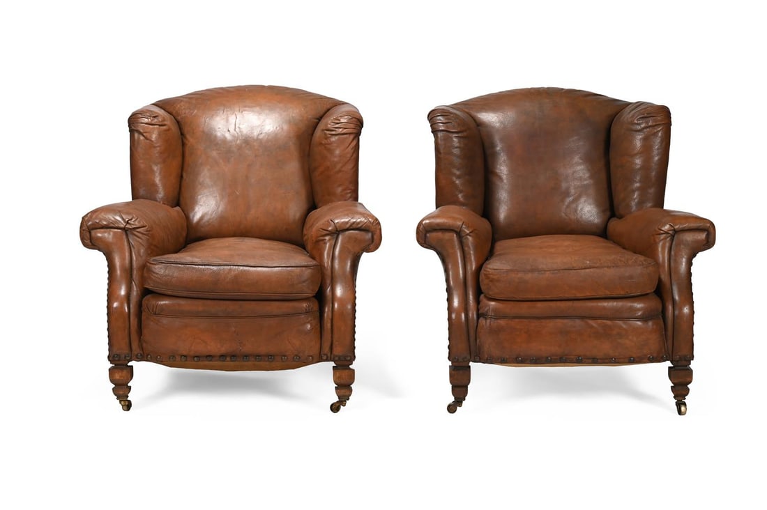 A PAIR OF EDWARDIAN BROWN HIDE UPHOSTERED WING ARMCHAIRS, BY S. J. WARING, CIRCA 1902 - 2