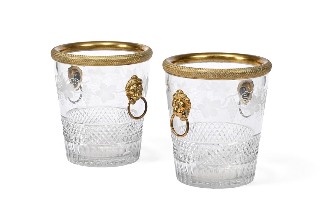 A PAIR OF GILT-METAL MOUNTED CRYSTAL CHAMPAGNE BUCKETS, PROBABLY BACCARAT OF PARIS, CIRCA 1900: A PAIR OF GILT-METAL MOUNTED ENGRAVED CRYSTAL SEAUX À BOUTEILLES OR CHAMPAGNE BUCKETS PROBABLY BACCARAT OF PARIS, CIRCA 1900 Decorated with fruiting vine and with two lion mask ring handles each