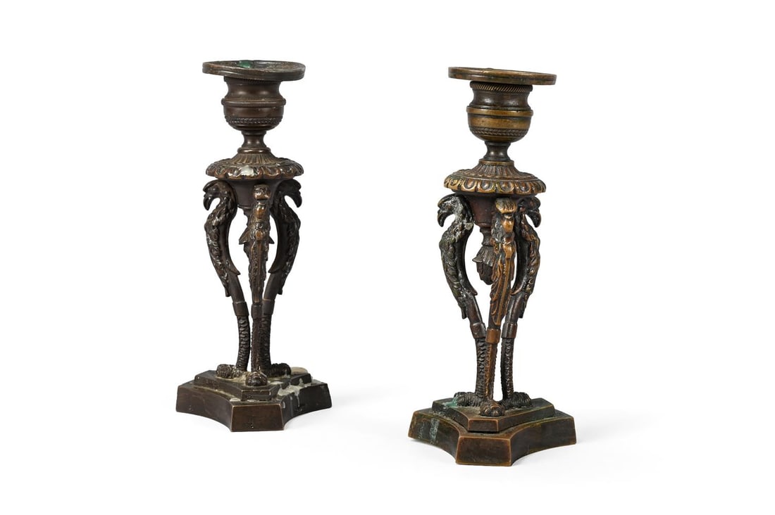 A PAIR OF GEORGE IV BRONZE CANDLESTICKS, CIRCA 1820: A PAIR OF GEORGE IV BRONZE CANDLESTICKS CIRCA 1820 With eagle headed monopodia supports 17cm high, 8cm wide