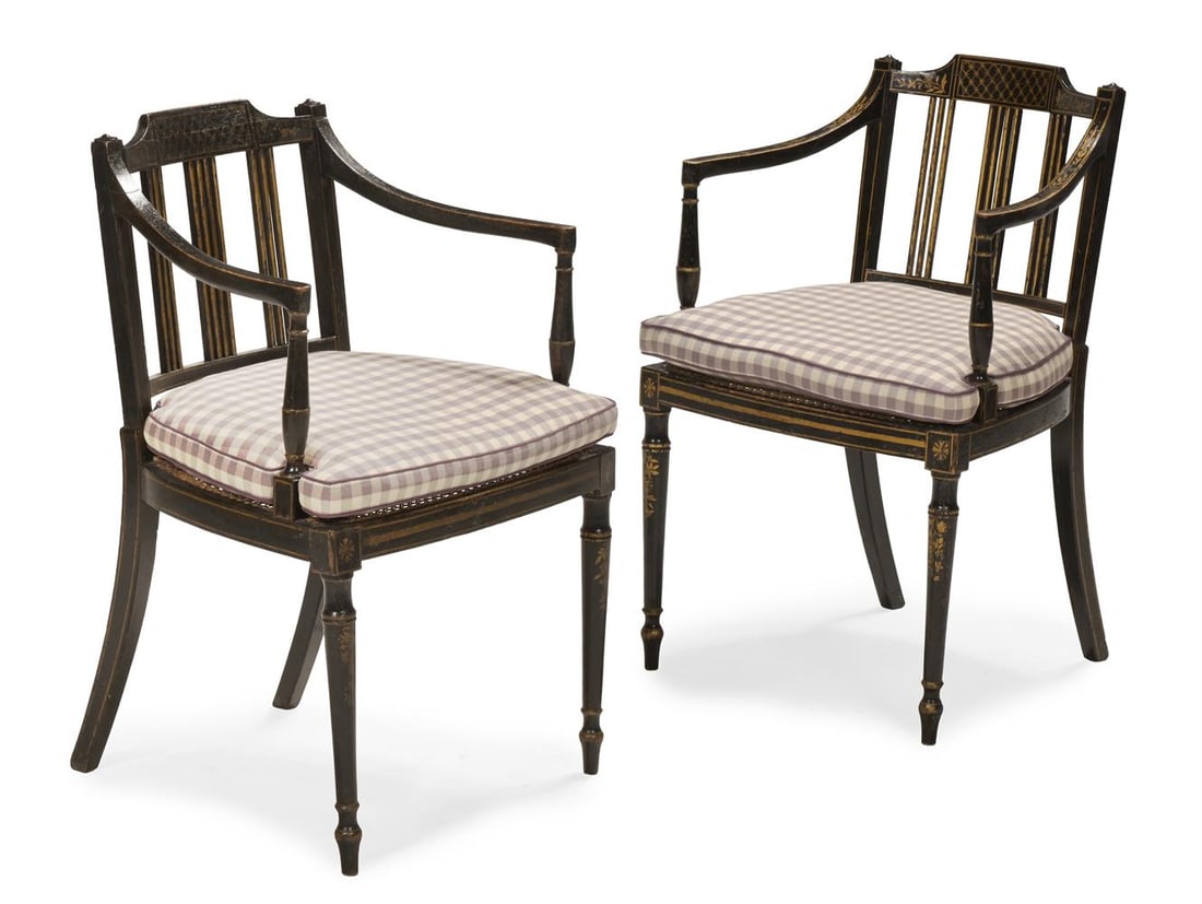 A PAIR OF REGENCY EBONISED AND PARCEL GILT OPEN ARMCHAIRS, FIRST QUARTER 19TH CENTURY: A PAIR OF REGENCY EBONISED AND PARCEL GILT OPEN ARMCHAIRS FIRST QUARTER 19TH CENTURY Seat cushions upholstered in Colefax & Fowler's 'Appledore Check' each 84cm high, 55cm wide, 52cm