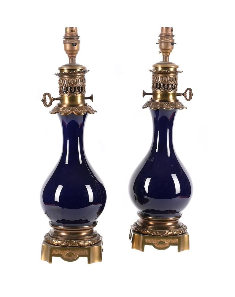 A PAIR OF FRENCH GILT METAL MOUNTED BLUE PORCELAIN TABLE LIGHTS, LATE 19TH CENTURY: A PAIR OF FRENCH GILT METAL MOUNTED BLUE PORCELAIN TABLE LIGHTS LATE 19TH CENTURY Later fitted for electricity 44cm high including fitment