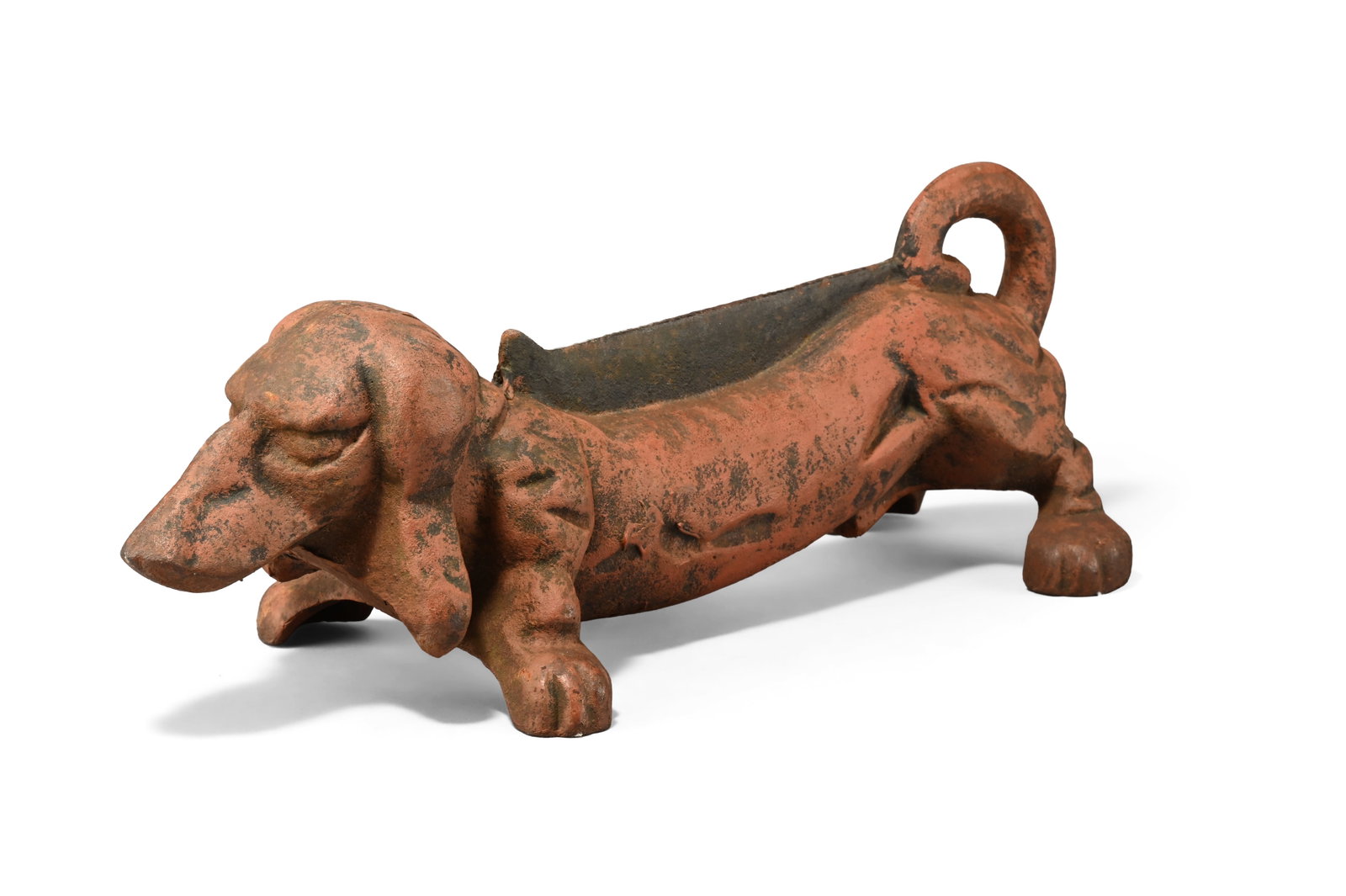 AN ART DECO CAST IRON DACSHUND BOOT SCRAPER OR DOOR STOP, FIRST HALF 20TH CENTURY: AN ART DECO CAST IRON DACSHUND BOOT SCRAPER OR DOOR STOP FIRST HALF 20TH CENTURY The body of the hound with inset boot scraping blade 13cm high, 46cm long, 9cm deep Condition Report Disclaimer