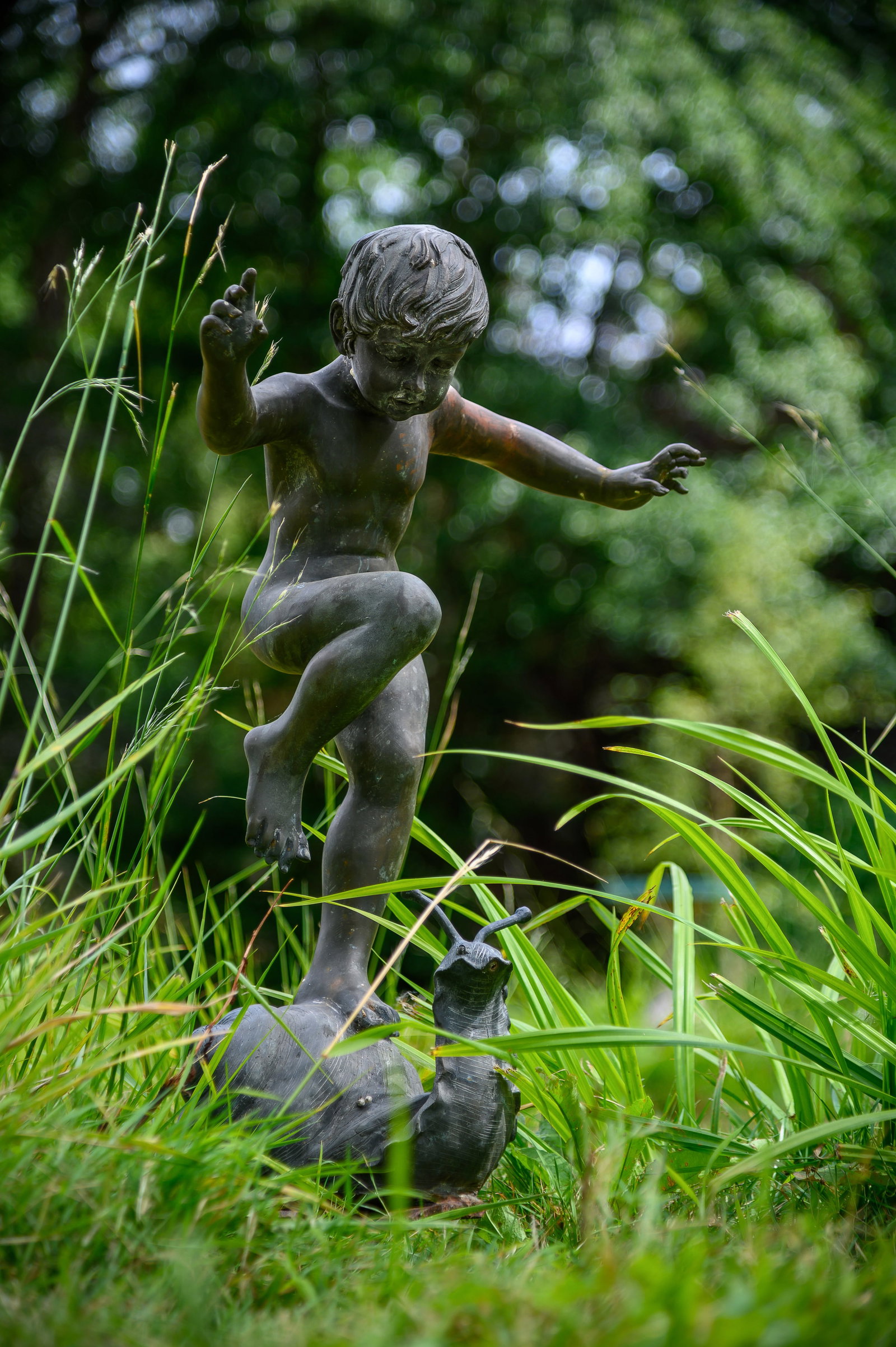 A BRONZED METAL FOUNTAIN MODELLED AS A CHILD ON A SNAIL, LATE 20TH CENTURY: A BRONZED METAL FOUNTAIN MODELLED AS A CHILD ON A SNAIL LATE 20TH CENTURY With claw base 84cm high Condition Report Disclaimer