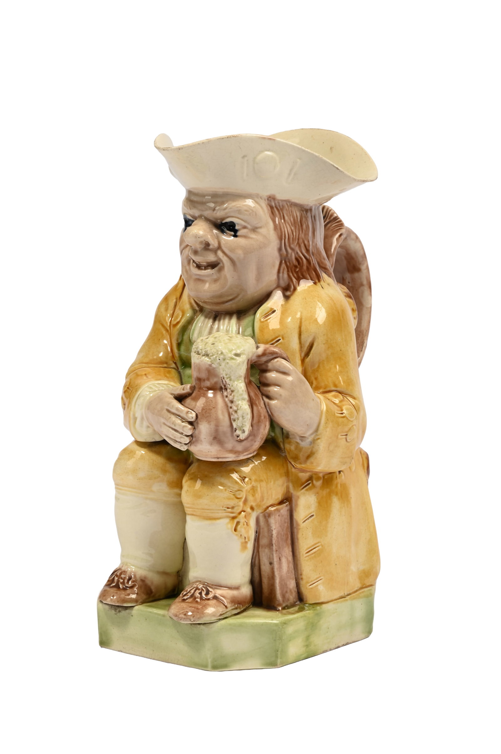 A STAFFORDSHIRE CREAMWARE TOBY JUG, LATE 18TH CENTURY: A STAFFORDSHIRE CREAMWARE TOBY JUG LATE 18TH CENTURY Decorated in coloured glazes in shades of brown, ochre and green, 24cm high Provenance: Paper label from The Moores Collection Condition