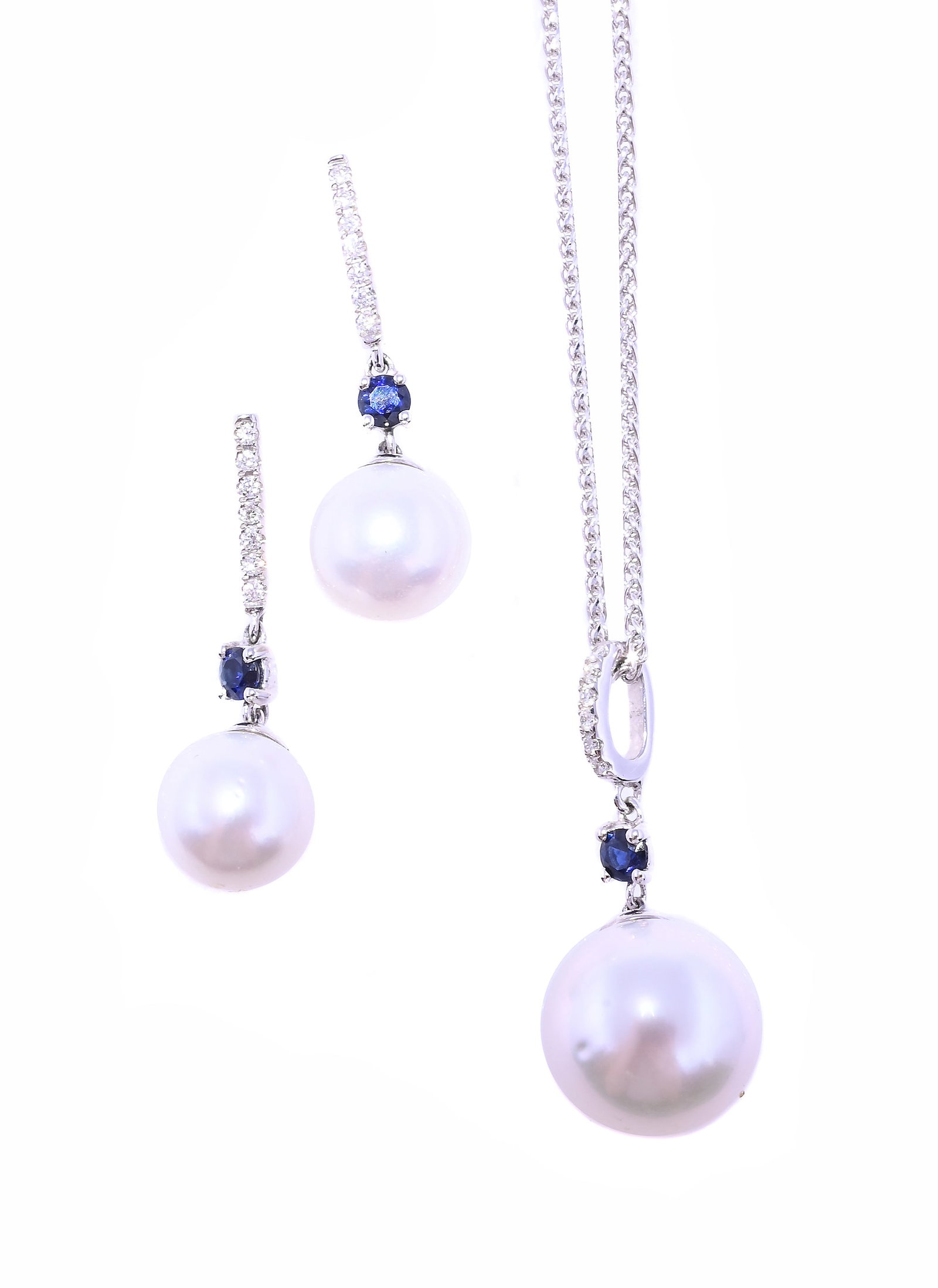 A SAPPHIRE, DIAMOND AND CULTURED PEARL EARRING AND PENDANT SET: A SAPPHIRE, DIAMOND AND CULTURED PEARL EARRING AND PENDANT SET The earrings with brilliant cut diamond set bars suspending a circular cut sapphire to a cultured pearl drop, stud fittings,