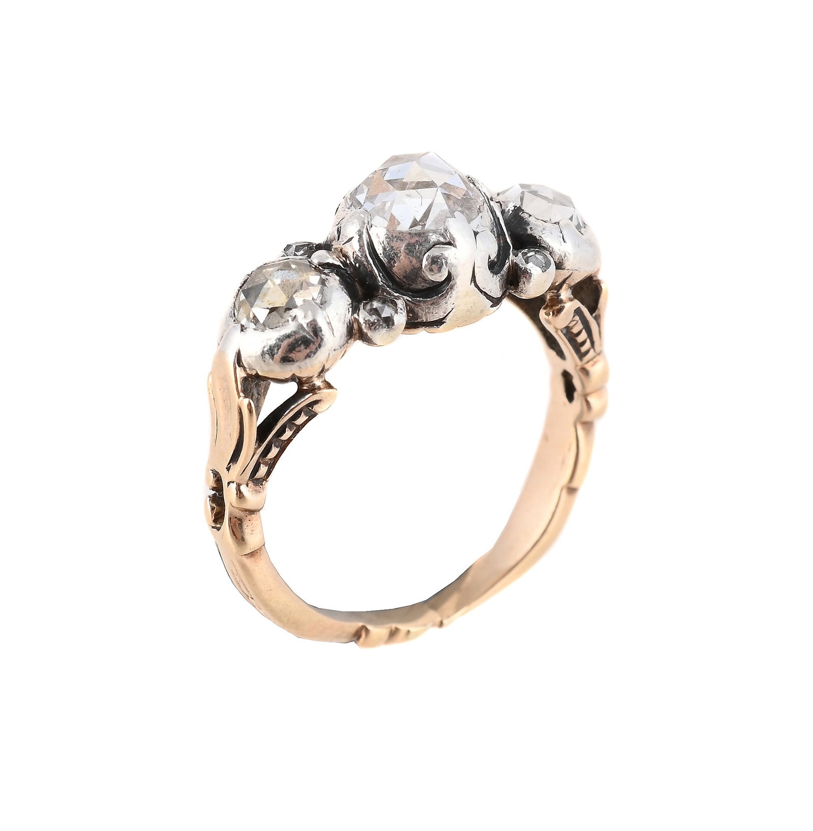 AN EARLY 20TH CENTURY DIAMOND THREE STONE RING: AN EARLY 20TH CENTURY DIAMOND THREE STONE RING The three rose cut diamonds in cut down collet settings, with closed backs, the shank with chased and foliate decoration, unmarked 