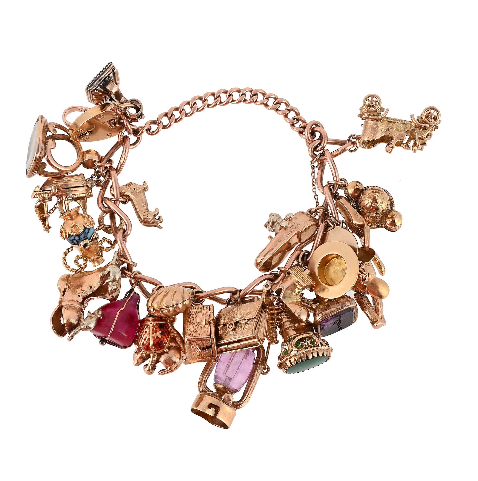 A 9CT GOLD CHARM BRACELET: A 9CT GOLD CHARM BRACELET The wide curb links suspending various charms, including a clam shell opening to reveal an imitation pearl, an articulated teddy bear, a model of Brighton Pavilion, an