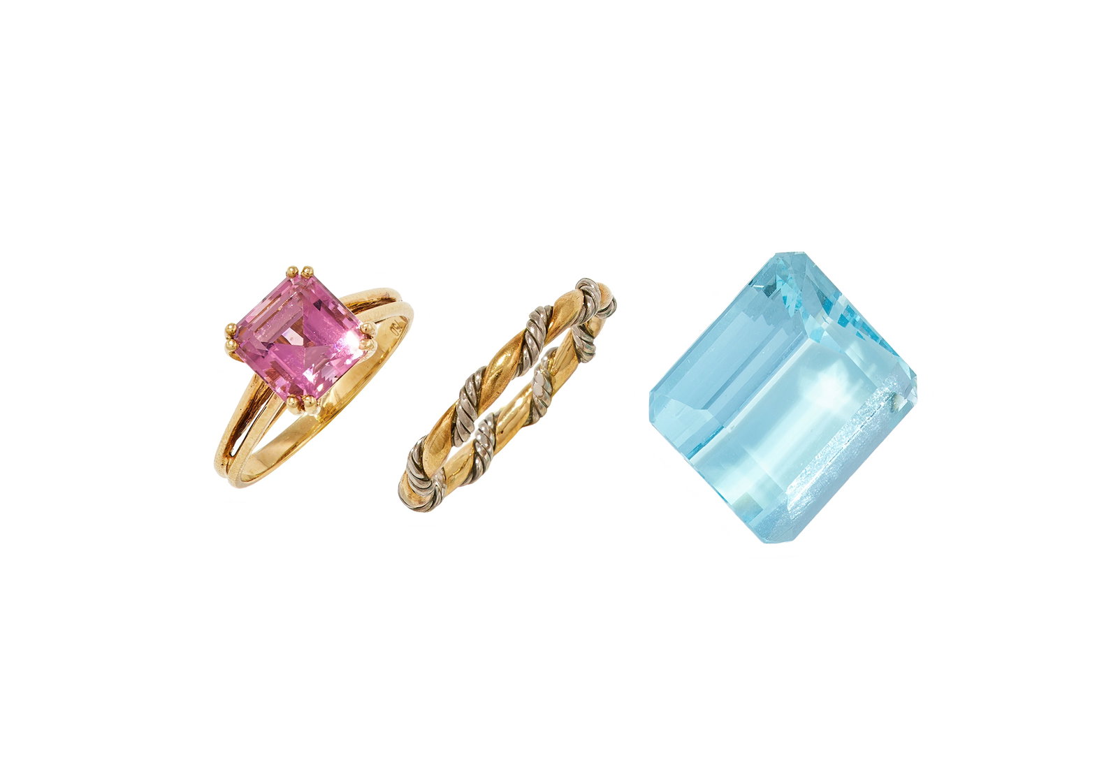 A SMALL GROUP OF JEWELLERY: A SMALL GROUP OF JEWELLERY Comprising: an unmounted rectangular step cut aquamarine, weighing 24.2 carats; a pink tourmaline single stone ring; and an 18ct bi-coloured gold twisted band ring, UK