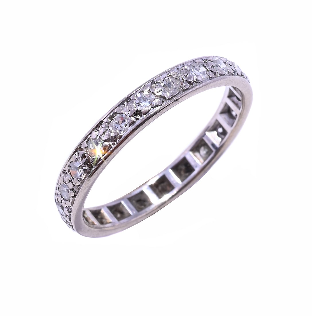 A DIAMOND ETERNITY RING: A DIAMOND ETERNITY RING The single cut diamonds in claw settings, unmarked Size/dimensions: ring size S Gross weight: 3.2 grams Condition Report: The ring has wear, thinning to claws,