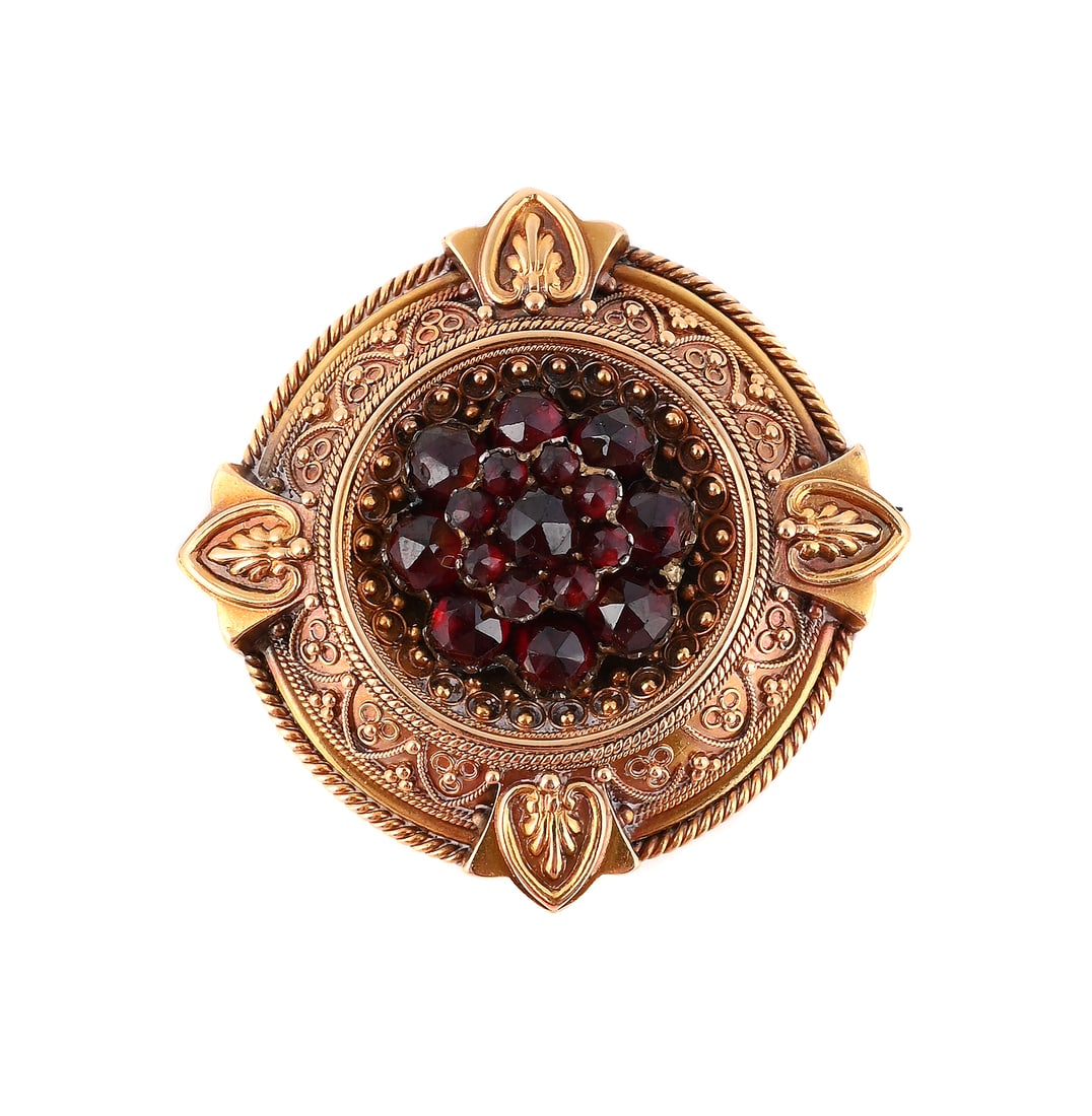 A VICTORIAN BOHEMIAN GARNET AND GOLD BROOCH, CIRCA 1880: A VICTORIAN BOHEMIAN GARNET AND GOLD BROOCH CIRCA 1880 The circular panel with beaded and ropetwist decoration, centred with a rose cut Bohemian garnet cluster, stamped 18