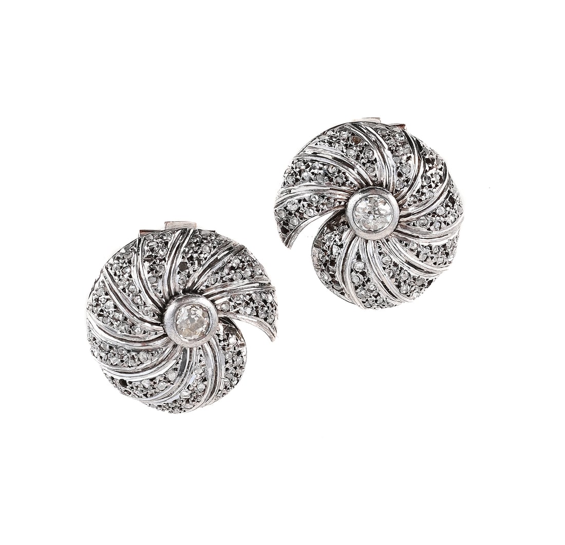 A PAIR OF DIAMOND EARRINGS: A PAIR OF DIAMOND EARRINGS The swirled panels set with rose cut diamonds, to central old European cut diamonds, clip fittings, unmarked Size/dimensions: 2.0cm long Gross weight: 11.6