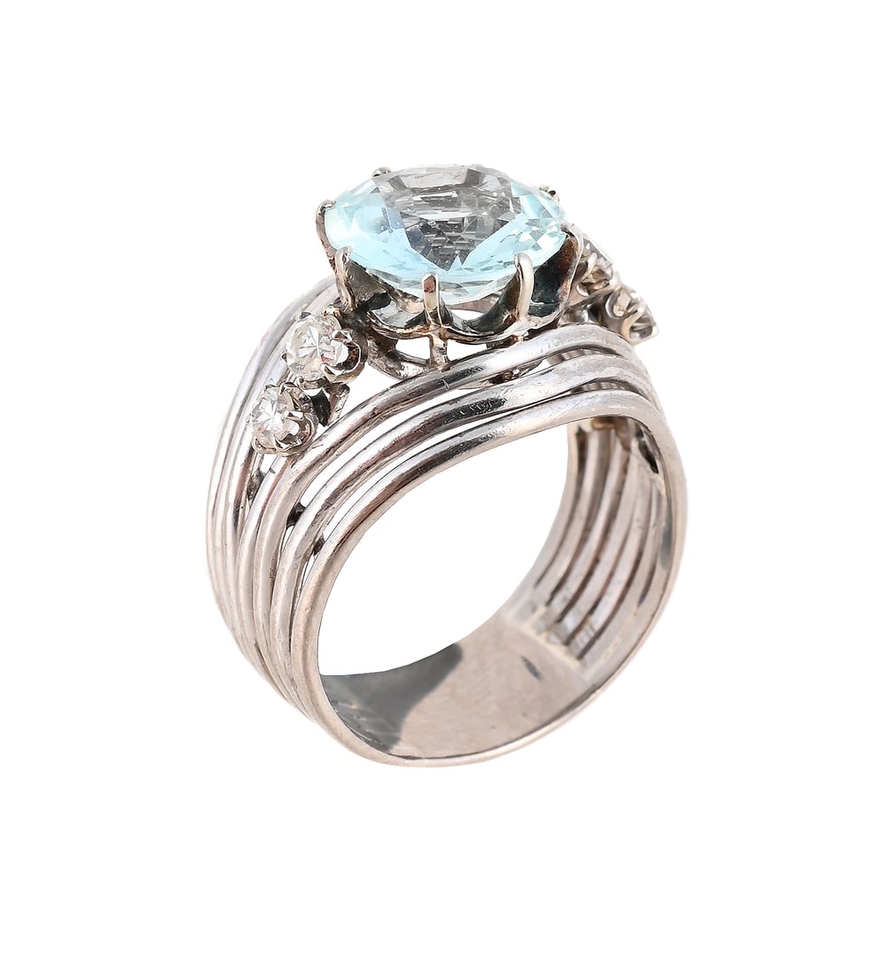 AN AQUAMARINE AND DIAMOND DRESS RING: AN AQUAMARINE AND DIAMOND DRESS RING The circular cut aquamarine between diamond two stone shoulders, within a wirework shank, unmarked Size/dimensions: ring size P Gross weight: 10.0 grams