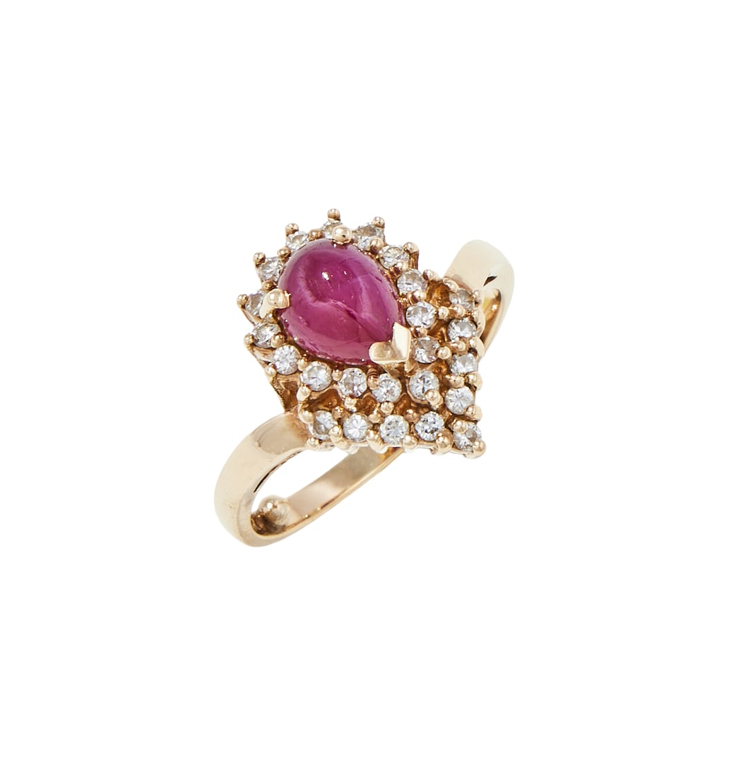 A RUBY AND DIAMOND DRESS RING: A RUBY AND DIAMOND DRESS RING The pear shaped cabochon ruby to a brilliant cut diamond surround and V-shaped shank, stamped 14K Size/dimensions: ring size L (sizing beads) Gross weight: 5.1 grams