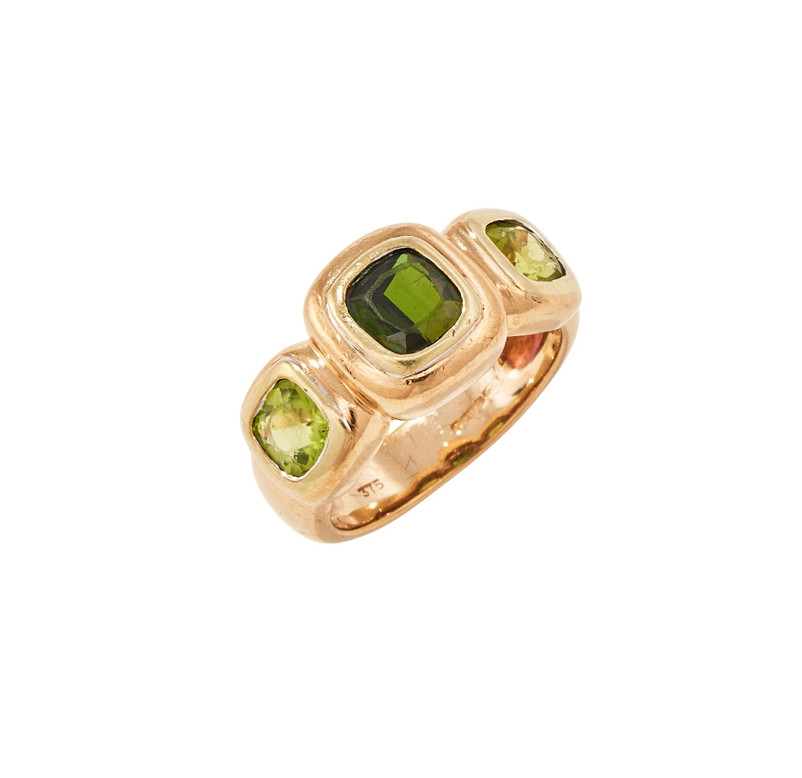 A PERIDOT AND TOURMALINE DRESS RING: A PERIDOT AND TOURMALINE DRESS RING The central squared cushion shaped green tourmaline flanked by cushion shaped peridots, in rubover settings, to a broad 9 carat gold shank, UK hallmark