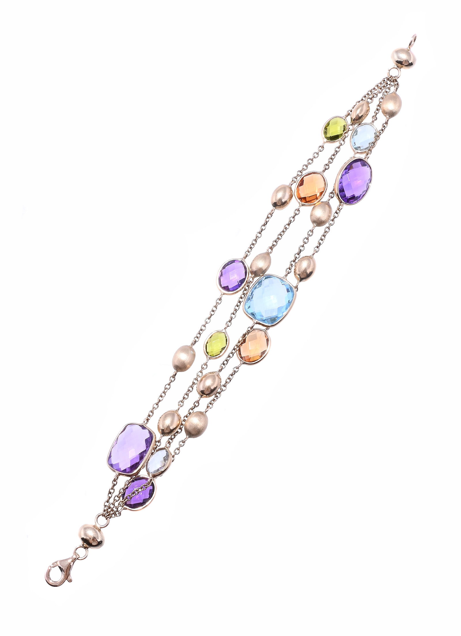 A 9 CARAT GOLD MULTI GEM SET BRACELET: A 9 CARAT GOLD MULTI GEM SET BRACELET The four rows of facetted oval and cushion shaped blue topaz, peridot, amethyst, with polished and textured bead spacers on belcher link chain connectors,