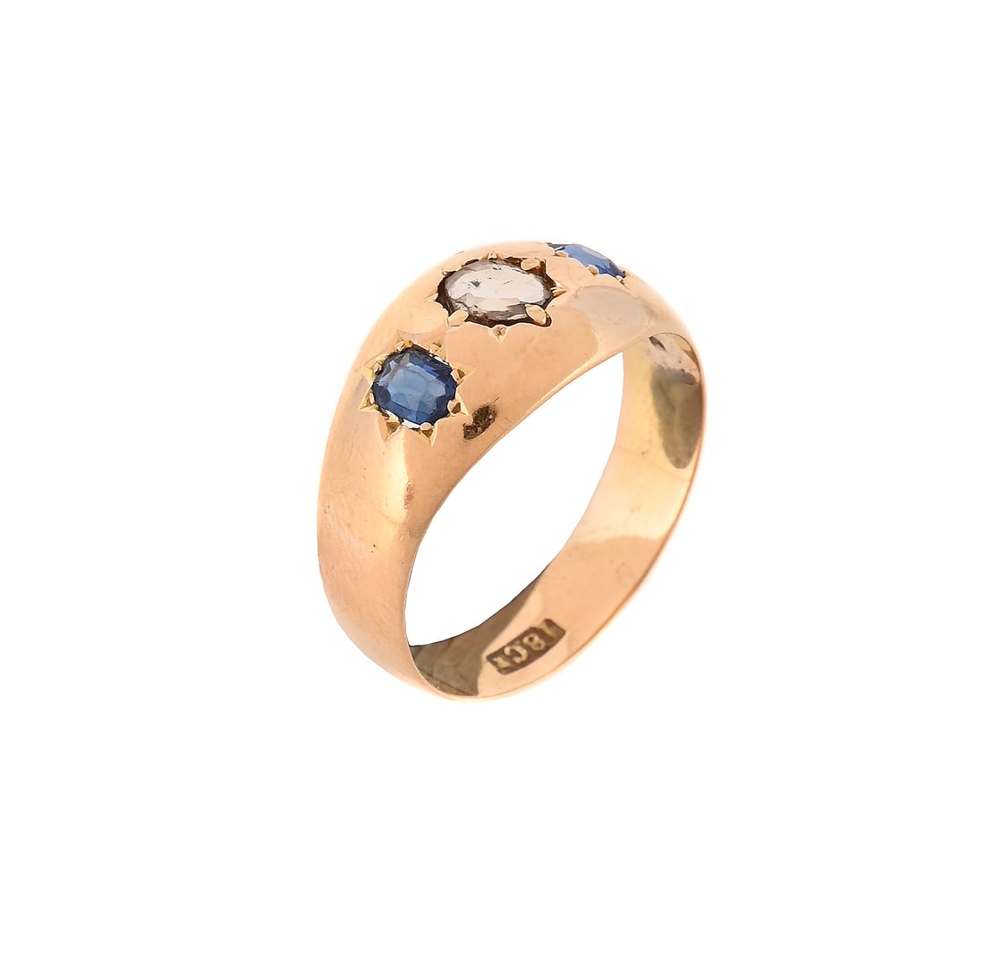 A SAPPHIRE AND DIAMOND THREE STONE RING: A SAPPHIRE AND DIAMOND THREE STONE RING The central rose cut diamond flanked by two cushion shaped sapphires, in star settings, stamped 18ct Size/dimensions: ring size R Gross weight: 3.8