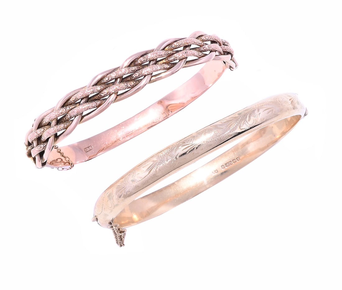 TWO GOLD BANGLES: TWO GOLD BANGLES The first circa 1900, with polished and woven front panel to a polished hinged back, stamped 9ct; the second with a scrolled foliate front section, Birmingham