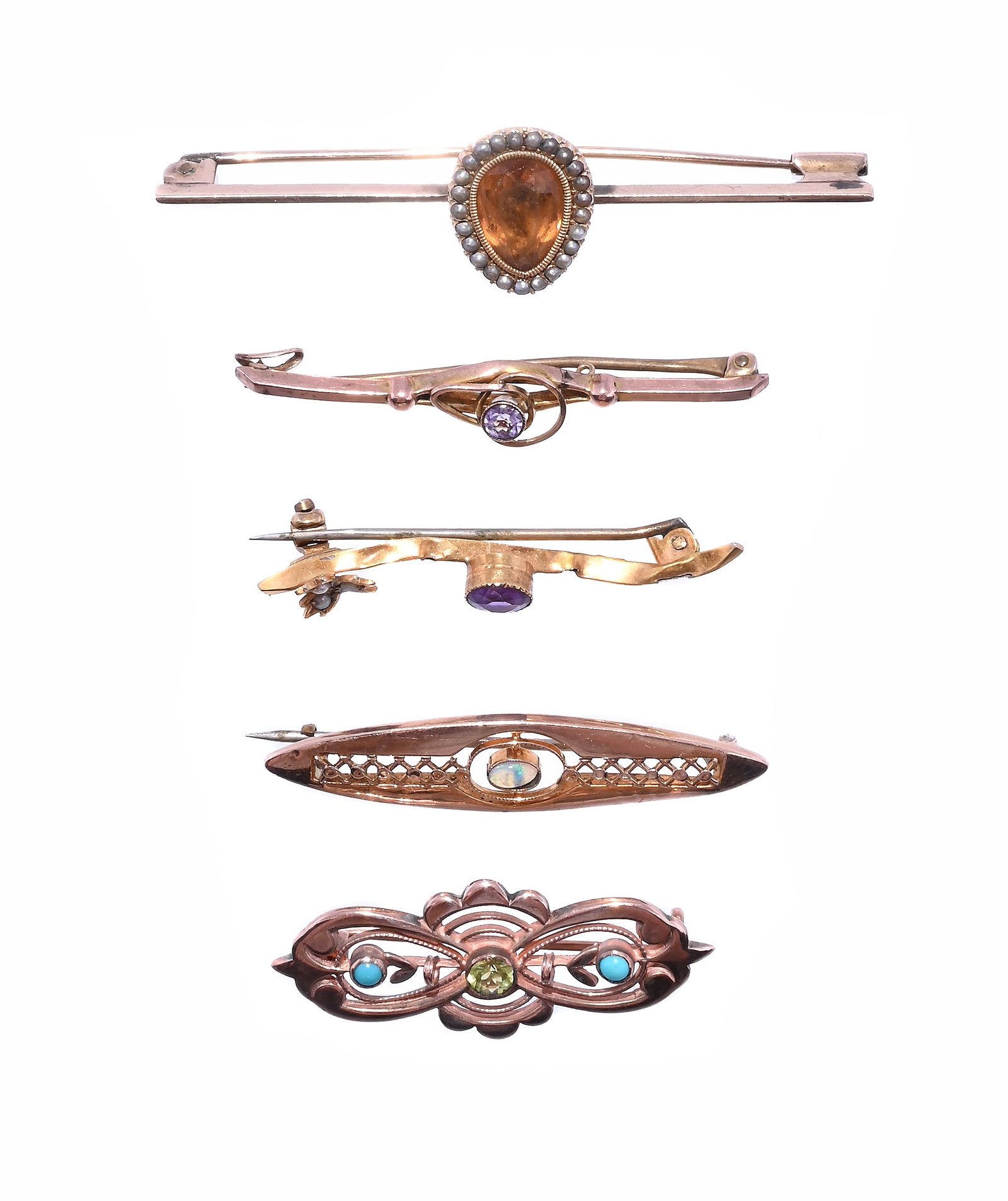 A SMALL COLLECTION OF BAR BROOCHES: A SMALL COLLECTION OF BAR BROOCHES The first with an orange stone within a half seed pearl surround, on a later bar brooch, unmarked; together with a 9ct gold pierced lobed brooch, centred with a