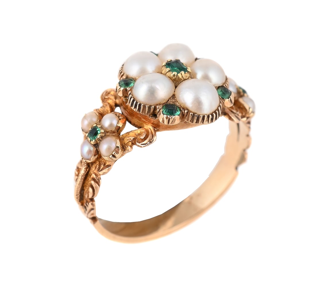 AN EARLY VICTORIAN HALF PEARL AND EMERALD CLUSTER RING: AN EARLY VICTORIAN HALF PEARL AND EMERALD CLUSTER RING CIRCA 1840 The half pearl cluster with mixed cut emeralds, to similarly set quatrefoil half pearl and emerald shoulders with chased foliate