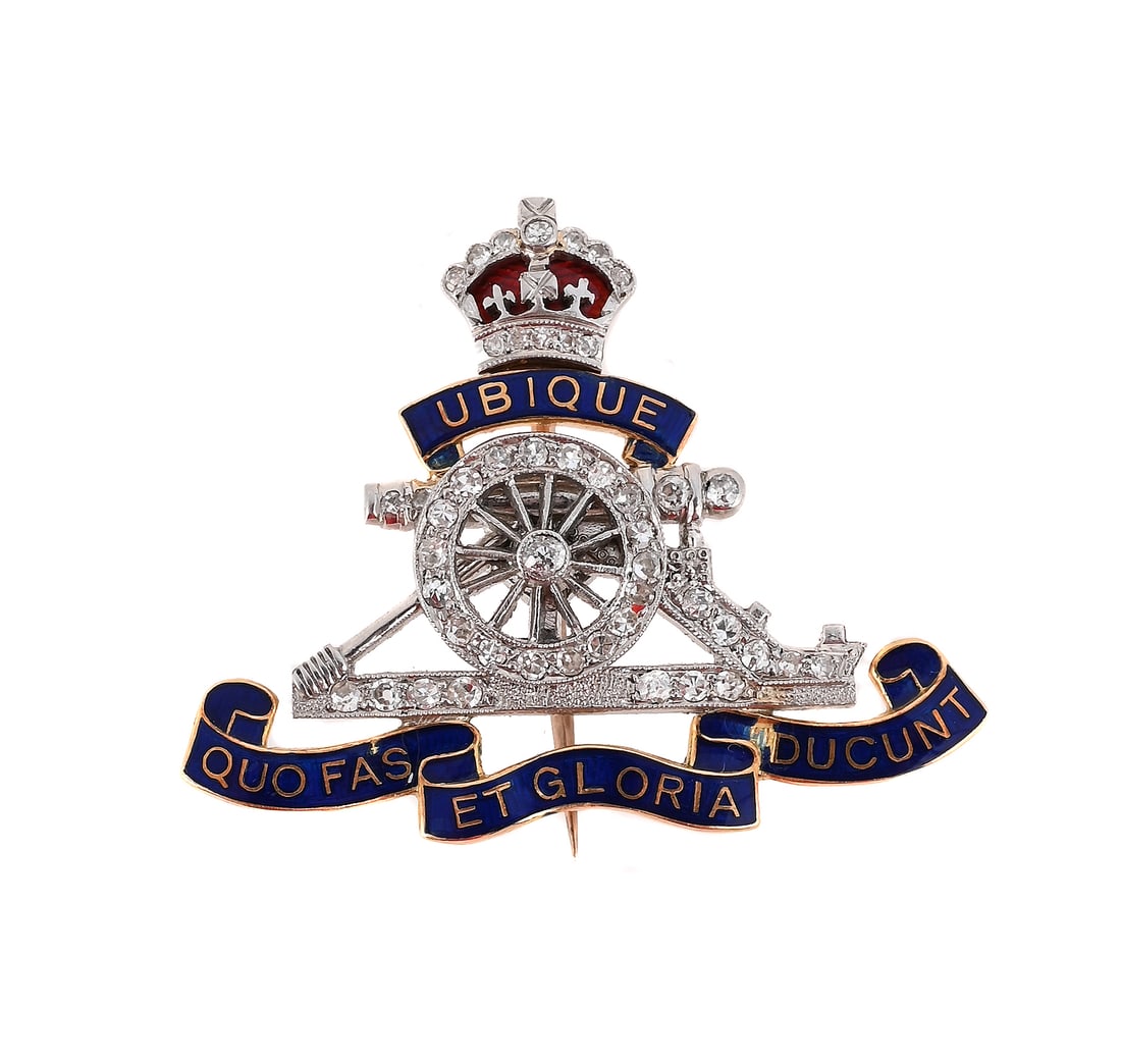 A MID 20TH CENTURY ROYAL ARTILLERY DIAMOND SET SWEETHEART BROOCH: A MID 20TH CENTURY ROYAL ARTILLERY DIAMOND SET SWEETHEART BROOCH The old and single cut diamond set cannon and crown surmount, with a blue enamelled banner inscribed with the motto 'Ubique Quo