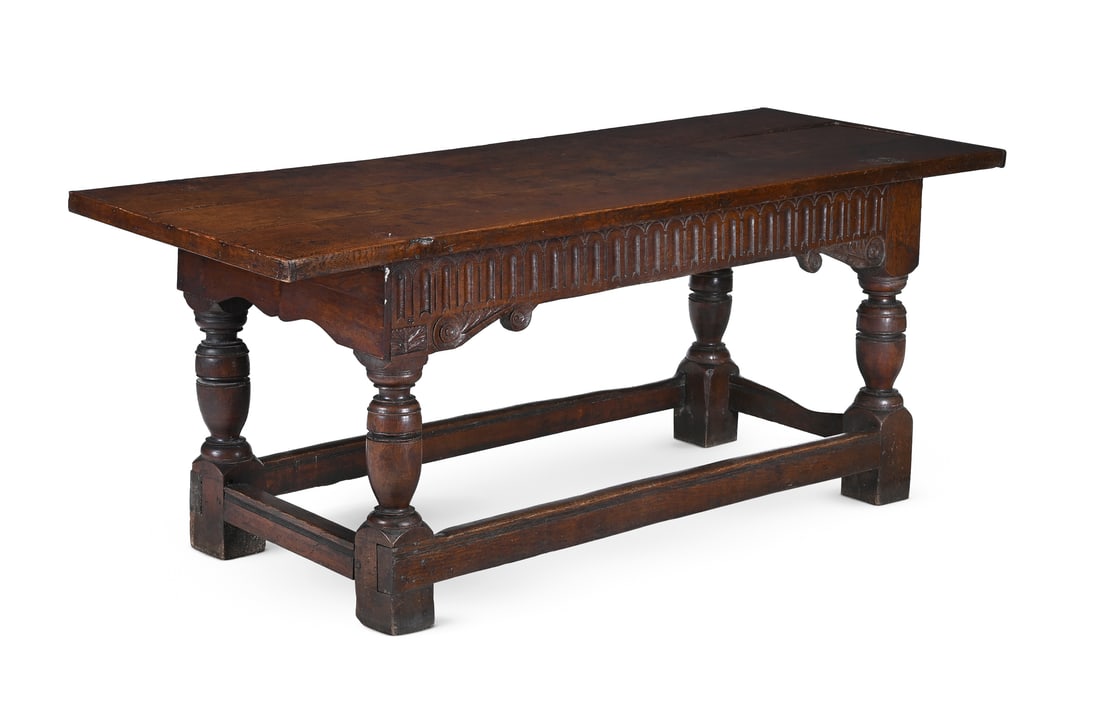 AN OAK HALL OR REFECTORY TABLE, MID 17TH CENTURY AND LATER: AN OAK HALL OR REFECTORY TABLEMID 17TH CENTURY AND LATERWith a quarter cut cleated plank top and a carved arcaded frieze to two faces, the left hand stile bearing journeyman's marks 'IB'80cm high, 210