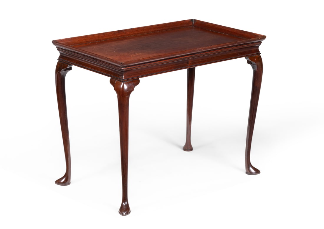 A GEORGE II MAHOGANY SILVER TABLE, CIRCA 1750: A GEORGE II MAHOGANY SILVER TABLECIRCA 1750The finely figured top with raised gallery above a concave moulded frieze, the cabriole legs on 'slipper' feet64cm high, 80.5cm wide, 47cm deepProvenance:Cor
