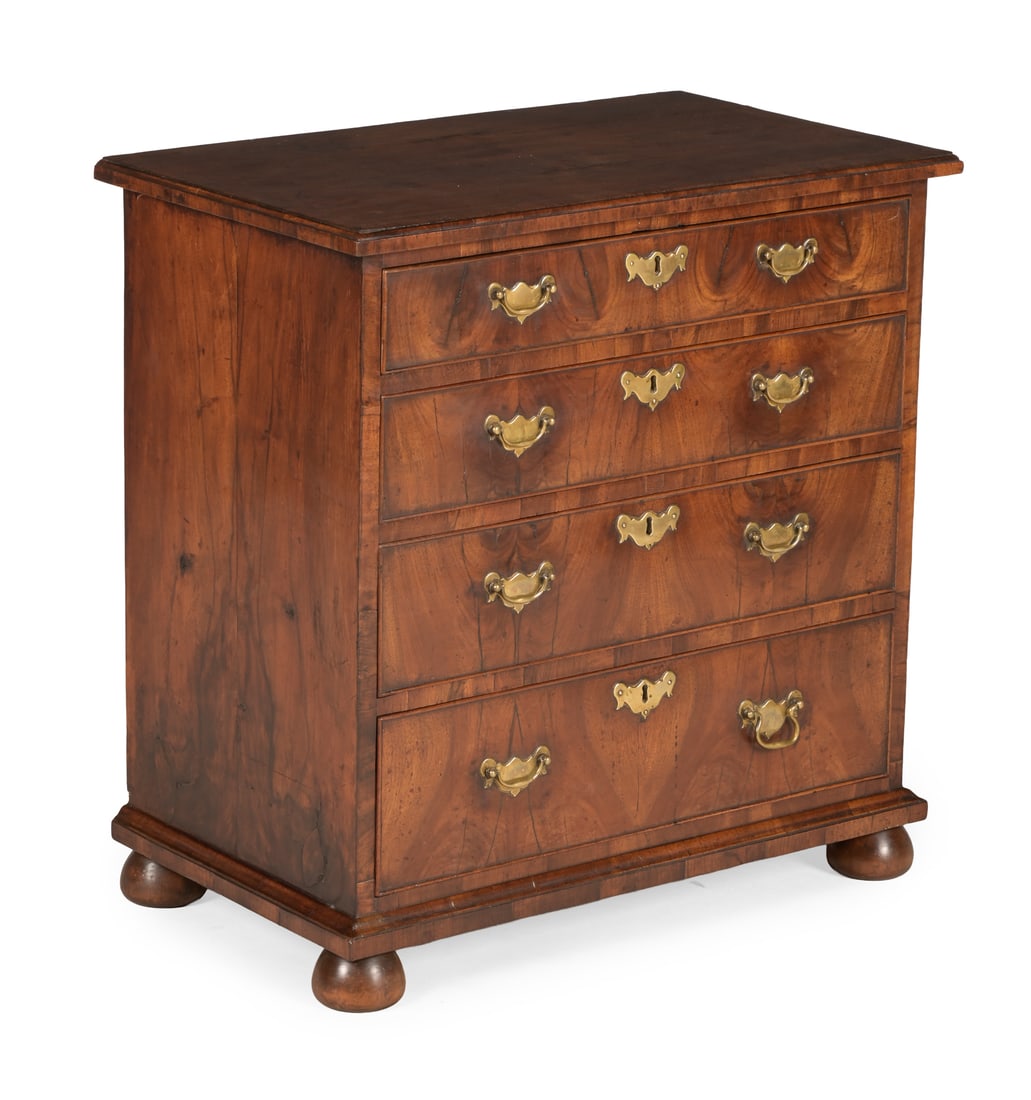 A GEORGE I WALNUT AND CROSSBANDED CHEST OF DRAWERS, CIRCA 1725 (1 of 3)