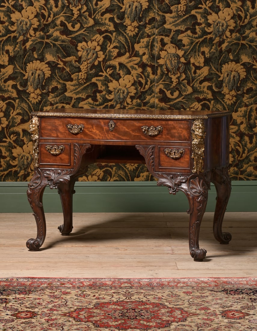 A FINE GEORGE II CARVED MAHOGANY AND GILT BRONZE MOUNTED COMMODE OR SIDE TABLE, CIRCA 1750: A FINE GEORGE II CARVED MAHOGANY AND GILT BRONZE MOUNTED COMMODE OR SIDE TABLEATTRIBUTED TO JOHN CHANNON, CIRCA 175077cm high, 106cm wide, 60cm deepThis finely executed mahogany and brass mounted comm