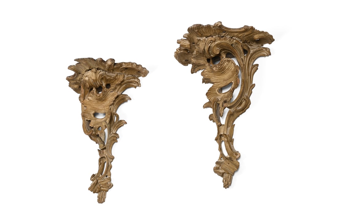 A PAIR OF GEORGE III CARVED AND OCHRE PAINTED WALL BRACKETS, CIRCA 1770: A PAIR OF GEORGE III CARVED AND OCHRE PAINTED WALL BRACKETSIN THE MANNER OF THOMAS CHIPPENDALE, CIRCA 177044.5cm high, 33cm wide, 19.5cm deep