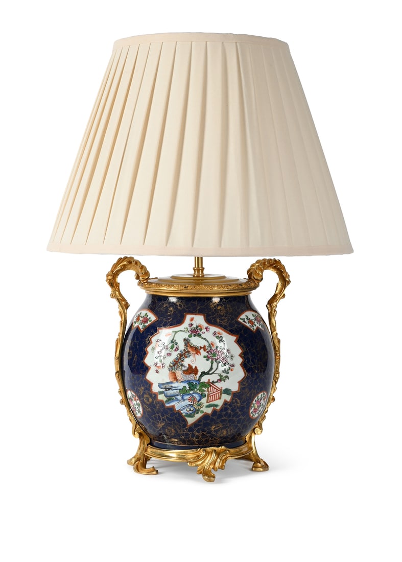 A FRENCH GILT METAL MOUNTED PORCELAIN VASE TABLE LIGHT, LATE 19TH CENTURY: A FRENCH GILT METAL MOUNTED PORCELAIN VASE TABLE LIGHT LATE 19TH CENTURY Fitted for electricity and with a pleated silk shade, PAT tested 29.5cm high excluding fitment, 59cm high overall including sha