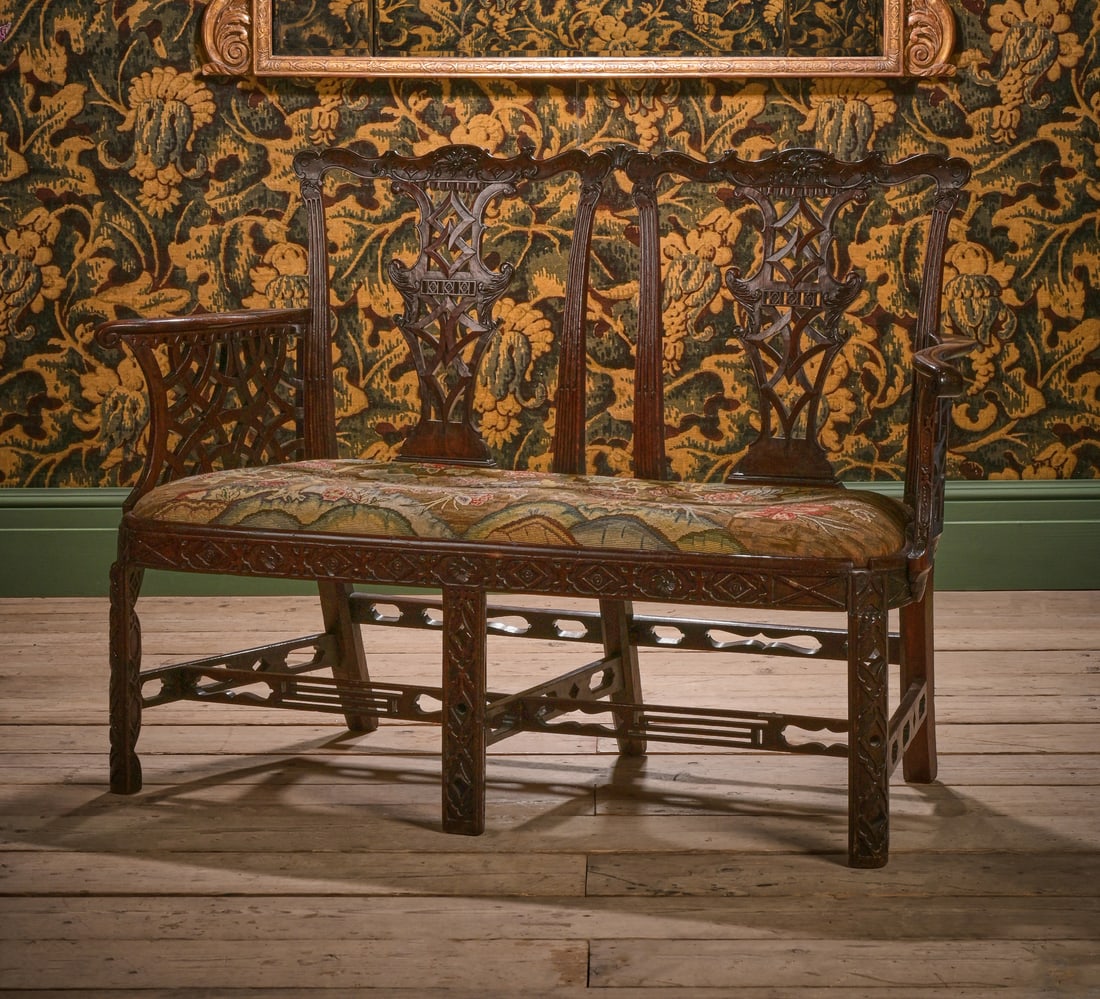 A GEORGE III CARVED MAHOGANY CHAIR BACK SETTEE, IN THE MANNER OF THOMAS CHIPPENDALE, CIRCA 1770 (1 of 2)
