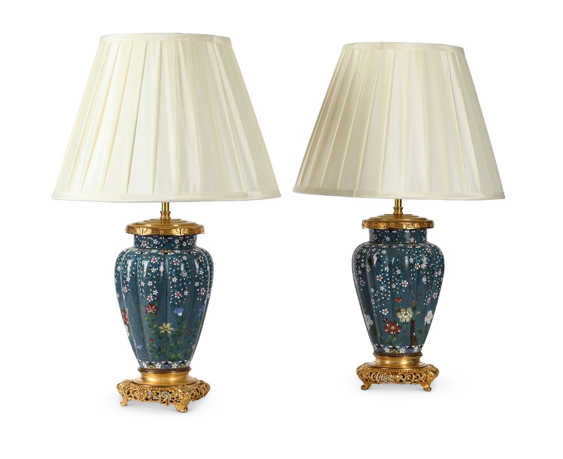 A PAIR OF GILT METAL MOUNTED CLOISONNÉ VASE TABLE LIGHTS, LATE 19TH CENTURY: A PAIR OF GILT METAL MOUNTED CLOISONNÉ VASE TABLE LIGHTS LATE 19TH CENTURY Each with floral decoration on green blue ground, fitted for electricity and with pleated silk shades, PAT tested the ba
