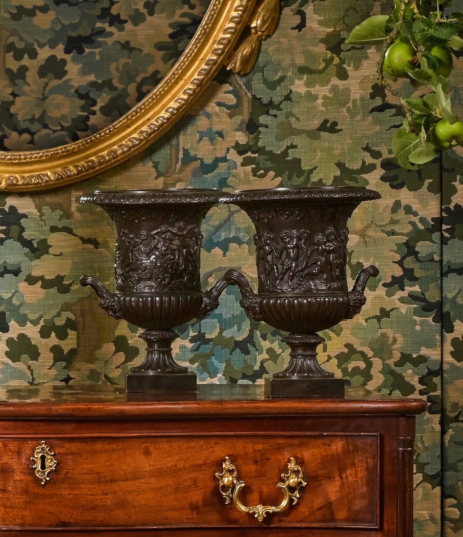 AFTER THE ANTIQUE, A PAIR OF ITALIAN BRONZE URNS BY BENEDETTO BOSCHETTI, LATE 19TH CENTURY: AFTER THE ANTIQUE, A PAIR OF ITALIAN BRONZE URNS BY BENEDETTO BOSCHETTI (1820-1879), LATE 19TH CENTURY Both signed B Boschetti, Roma, each with gamboling cherub decoration to the twin handle