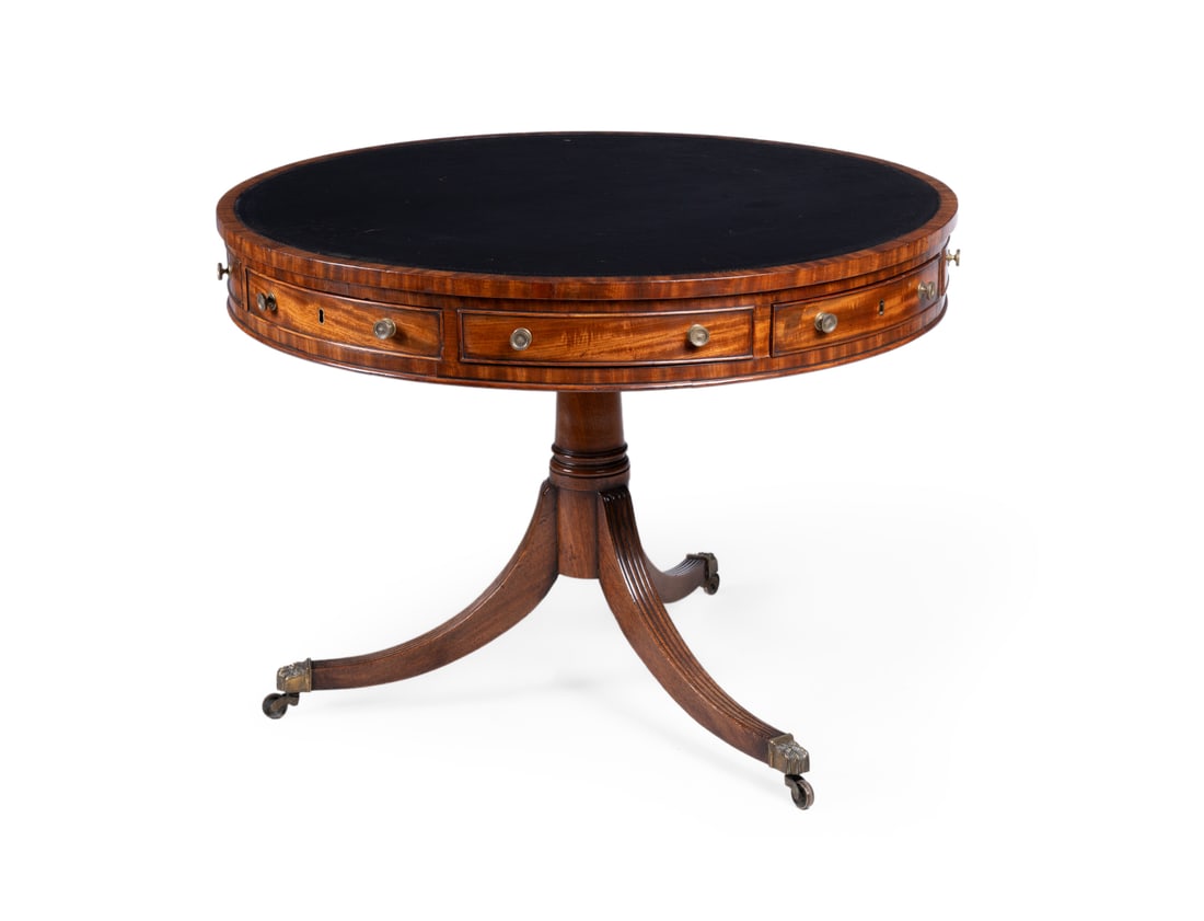 A REGENCY MAHOGANY DRUM LIBRARY TABLE, CIRCA 1815: A REGENCY MAHOGANY DRUM LIBRARY TABLECIRCA 1815With a tooled leather inset top above four drawers and four false drawers79cm high, 106cm diameter