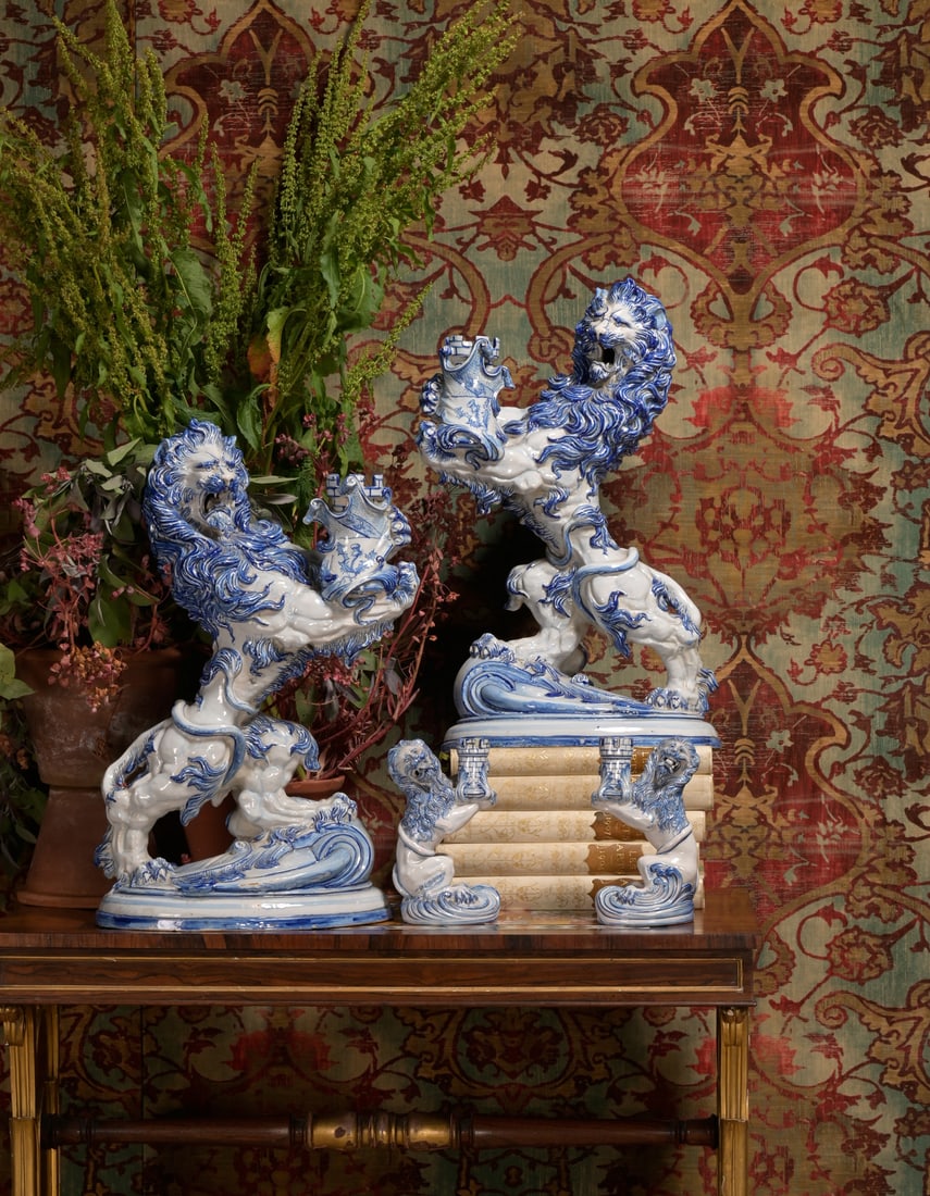 A PAIR OF LUNEVILLE (ST. CLÉMENT FAÏENCERIE) BLUE AND WHITE MODELS OF HERALDIC LIONS: A PAIR OF LUNEVILLE (ST. CLÉMENT FAÏENCERIE) BLUE AND WHITE MODELS OF HERALDIC LIONSLATE 19TH CENTURYWith blue factory marks64cm high, 39cm wide, 29cm deep TOGETHER WITH ANOTHER SMALLER PAIR