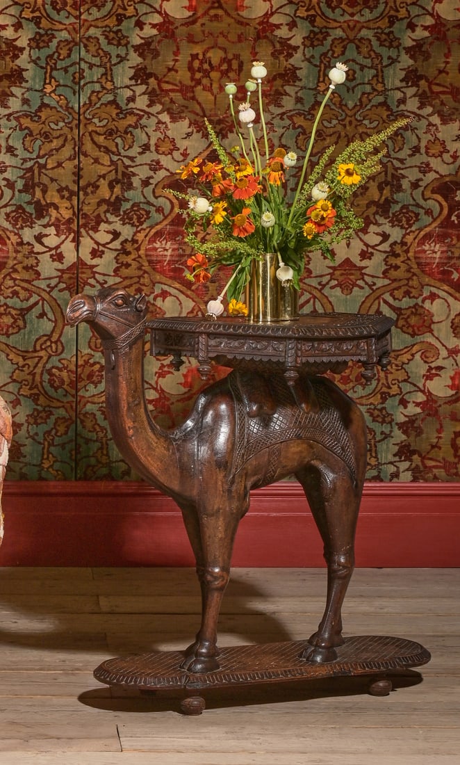 Y A N ANGLO INDIAN CARVED HARDWOOD CAMEL OCCASIONAL TABLE, 20TH CENTURY: Y AN ANGLO INDIAN CARVED HARDWOOD CAMEL OCCASIONAL TABLE20TH CENTURY74cm high, 82cm long, 47cm wide ϒ Indicates that this lot may be subject to CITES regulations when exported. The import of lots