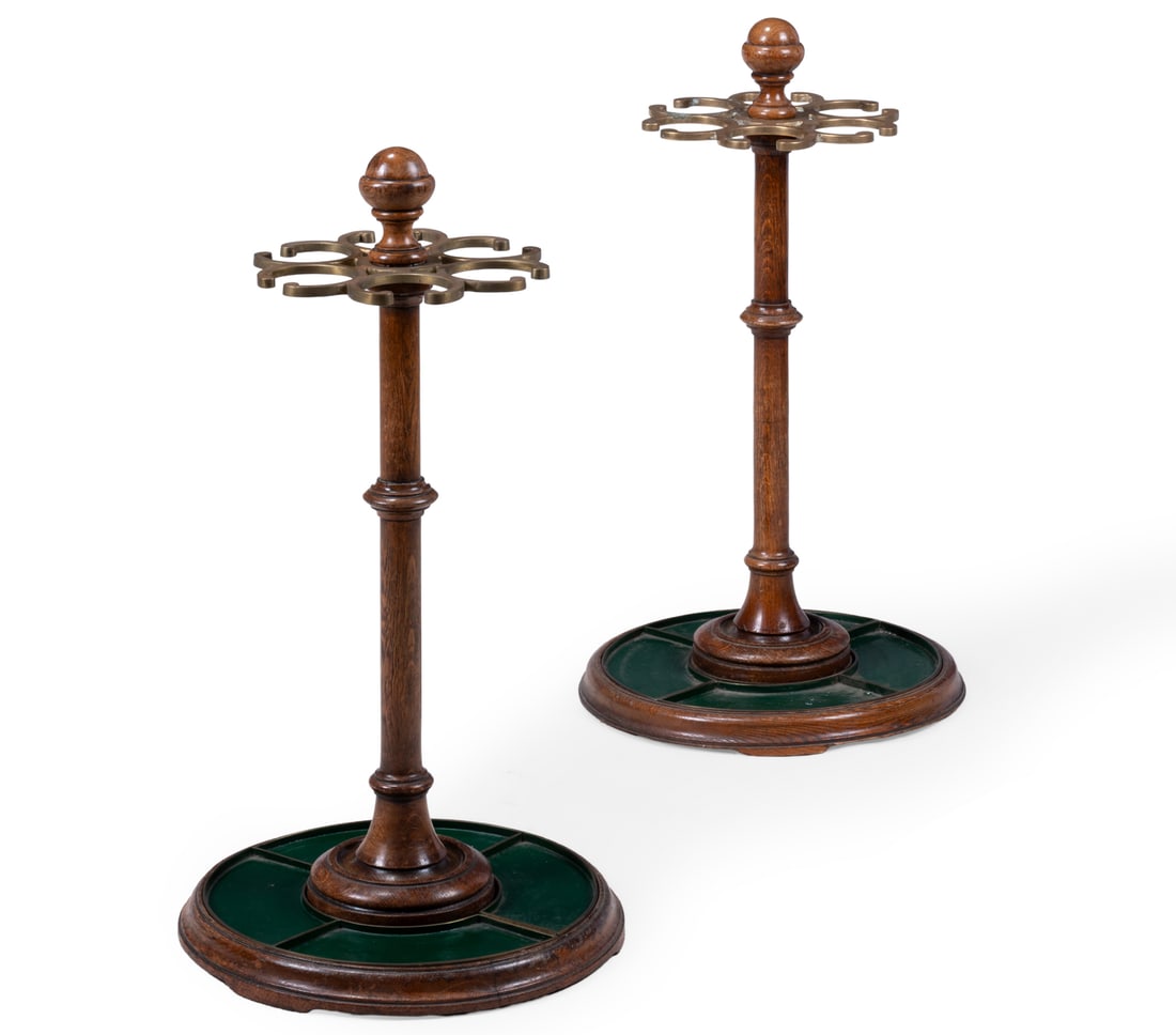 A PAIR OF VICTORIAN OAK AND BRASS STICK STANDS, CIRCA 1890: A PAIR OF VICTORIAN OAK AND BRASS STICK STANDSCIRCA 1890With painted tin drip trays87cm high, 44cm diameter at the base