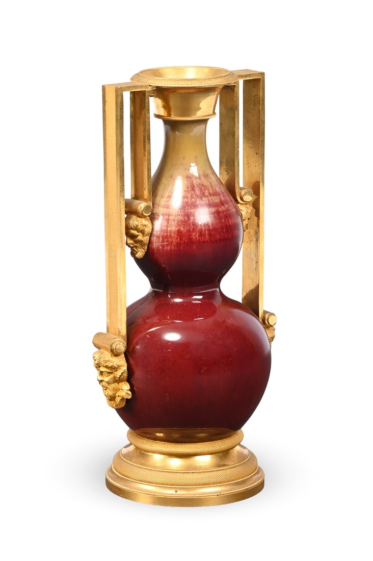 A REGENCY GILT BRONZE MOUNTED CHINESE PORCELAIN VASE, ATTRIBUTED TO VULLIAMY, EARLY 19TH CENTURY: A REGENCY GILT BRONZE MOUNTED CHINESE PORCELAIN VASEATTRIBUTED TO VULLIAMY, EARLY 19TH CENTURY The graduated ox blood red double gourd body with double twin handle mounts with masks, turned stepped fo