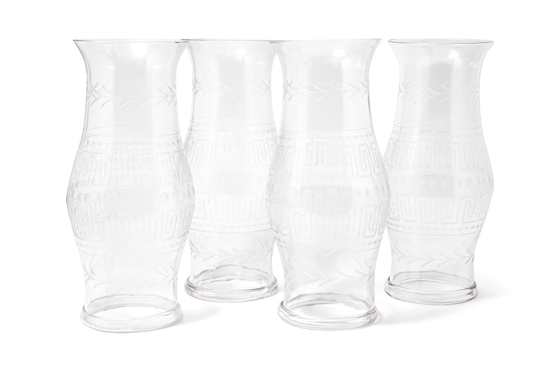 A SET OF FOUR ETCHED GLASS HURRICANE SHADES, CONTEMPORARY: A SET OF FOUR ETCHED GLASS HURRICANE SHADES CONTEMPORARY With Greek key design Slight size variance in design and heightapproximately 56cm high, the bases 21cm diameter