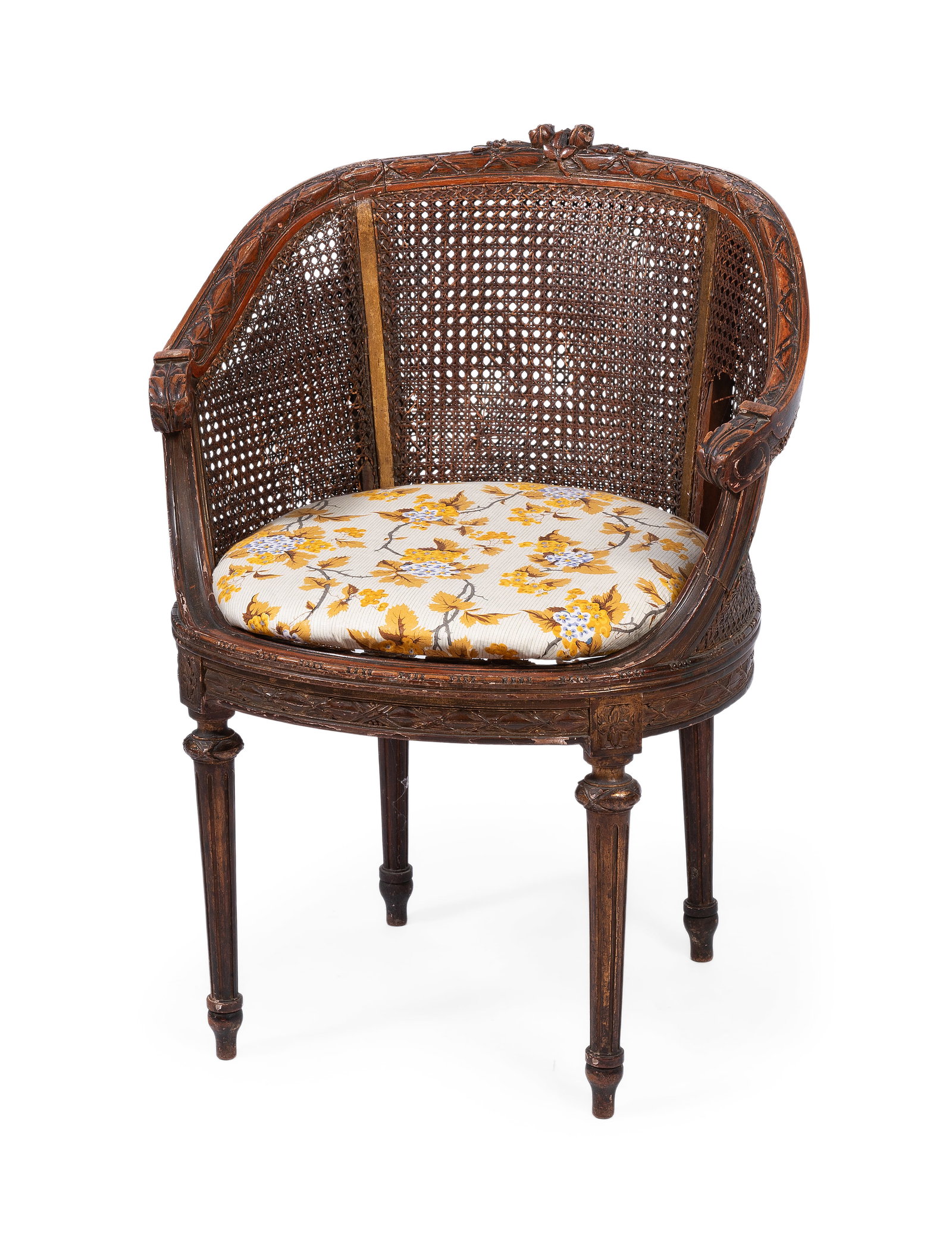 A BEECH SMALL CANED BERGERE IN LOUIS XVI STYLE, EARLY 20TH CENTURY: A BEECH SMALL CANED BERGERE IN LOUIS XVI STYLE EARLY 20TH CENTURY With a Sibyl Colefax & John Fowler ‘Ebury’ fabric cushion 61cm high, 61cm wide, 37cm deep Condition Report: