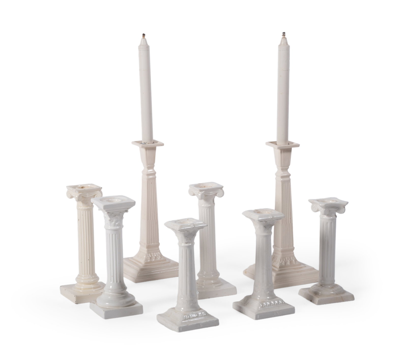 A PAIR OF ENGLISH CREAMWARE COLUMNAR CANDLESTICKS, LATE 20TH CENTURY, WITH SIX SIMILAR EXAMPLES: A PAIR OF ENGLISH CREAMWARE COLUMNAR CANDLESTICKS LATE 20TH CENTURY 27cm high Together with six assorted British and Continental cream coloured pottery columnar candlesticks, 21cm high and smaller