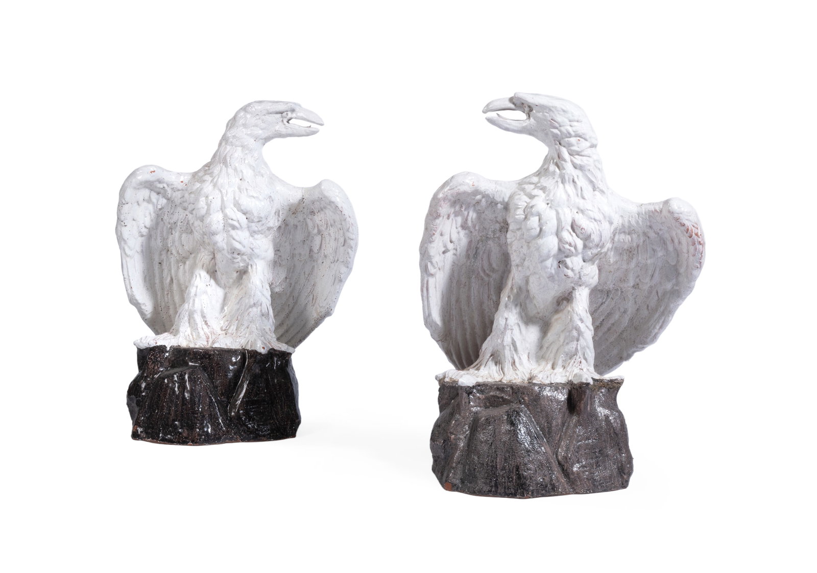 A PAIR OF CONTINENTAL WHITE-GLAZED TERRACOTTA MODELS OF EAGLES, EARLY 20TH CENTURY: A PAIR OF CONTINENTAL WHITE-GLAZED TERRACOTTA MODELS OF EAGLES EARLY 20TH CENTURY Modelled perched on an outcrop and facing left and right 74cm and 77cm high Provenance: Dreweatts, Fine Furniture,
