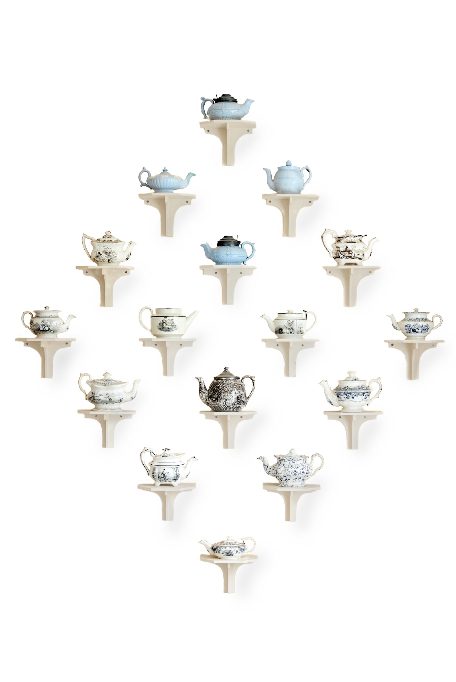 A COLLECTION OF MOSTLY STAFFORDSHIRE PRINTED SMALL TEAPOTS AND COVERS, AND WALL BRACKETS: A COLLECTION OF MOSTLY STAFFORDSHIRE PRINTED SMALL TEAPOTS AND COVERS VARIOUS DATES 19TH CENTURY 11.5cm high and smaller Together with wall brackets designed and painted by George Oakes Condition