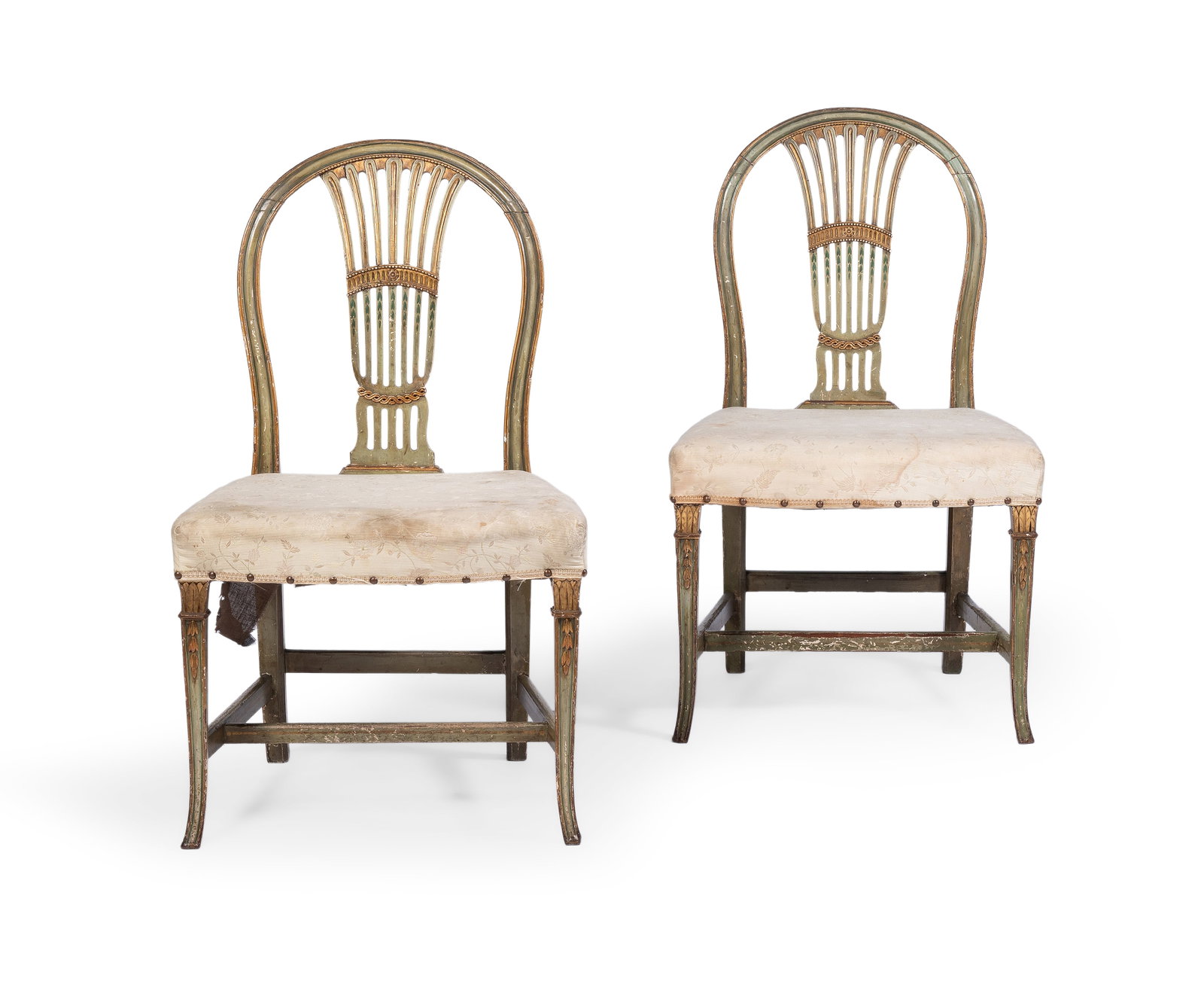 A PAIR OF GEORGE III GREEN PAINTED AND PARCEL GILT SIDE CHAIRS, CIRCA 1790: A PAIR OF GEORGE III GREEN PAINTED AND PARCEL GILT SIDE CHAIRS CIRCA 1790 92cm high, 57cm wide, 50cm deep For a pair of unpainted chairs with hoop backs and similarly carved and splayed legs, see