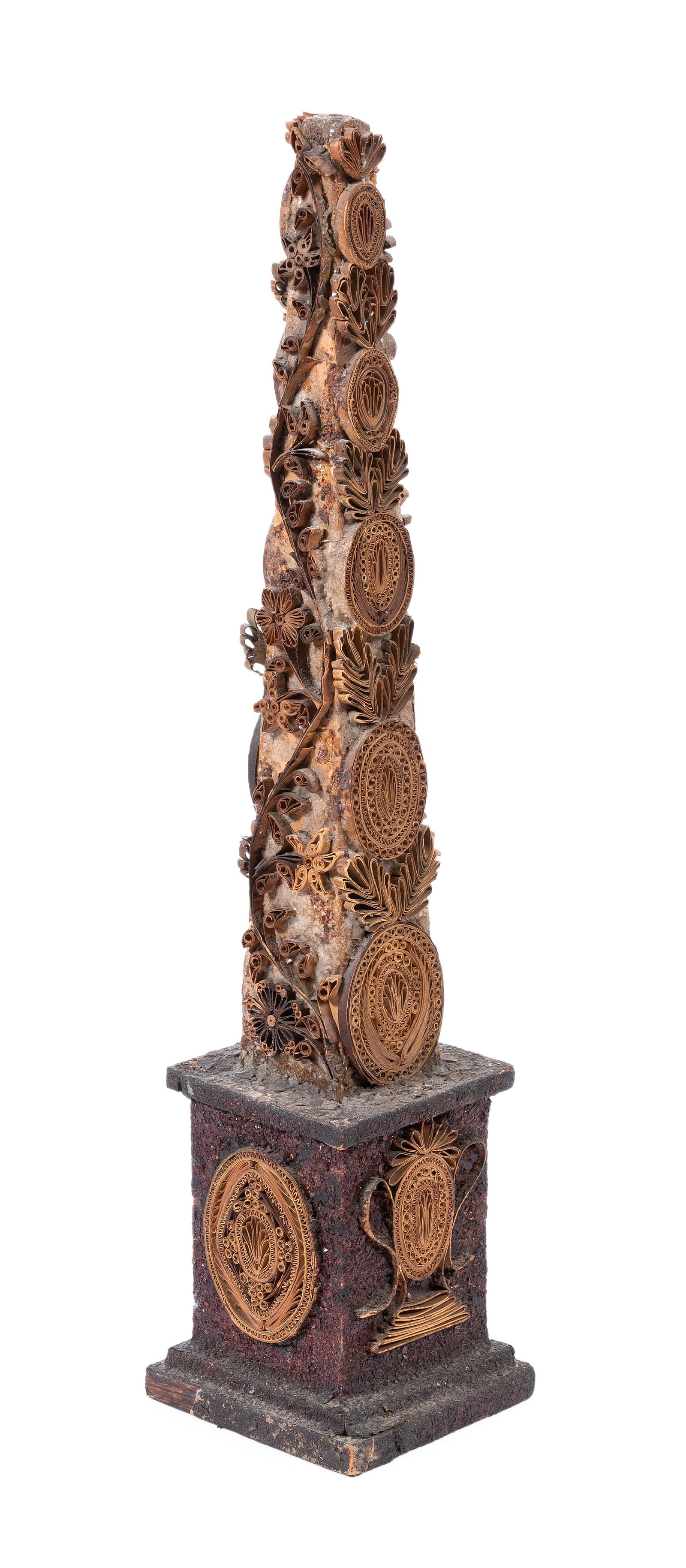 A GEORGE III PAPER SCROLL WORK OBELISK, LATE 18TH OR EARLY 19TH CENTURY: A GEORGE III PAPER SCROLL WORK OBELISK LATE 18TH OR EARLY 19TH CENTURY With a paper label ‘This was left to me in his will by the late John Fowler, C.B.E.’ 35cm high Provenance: A gift