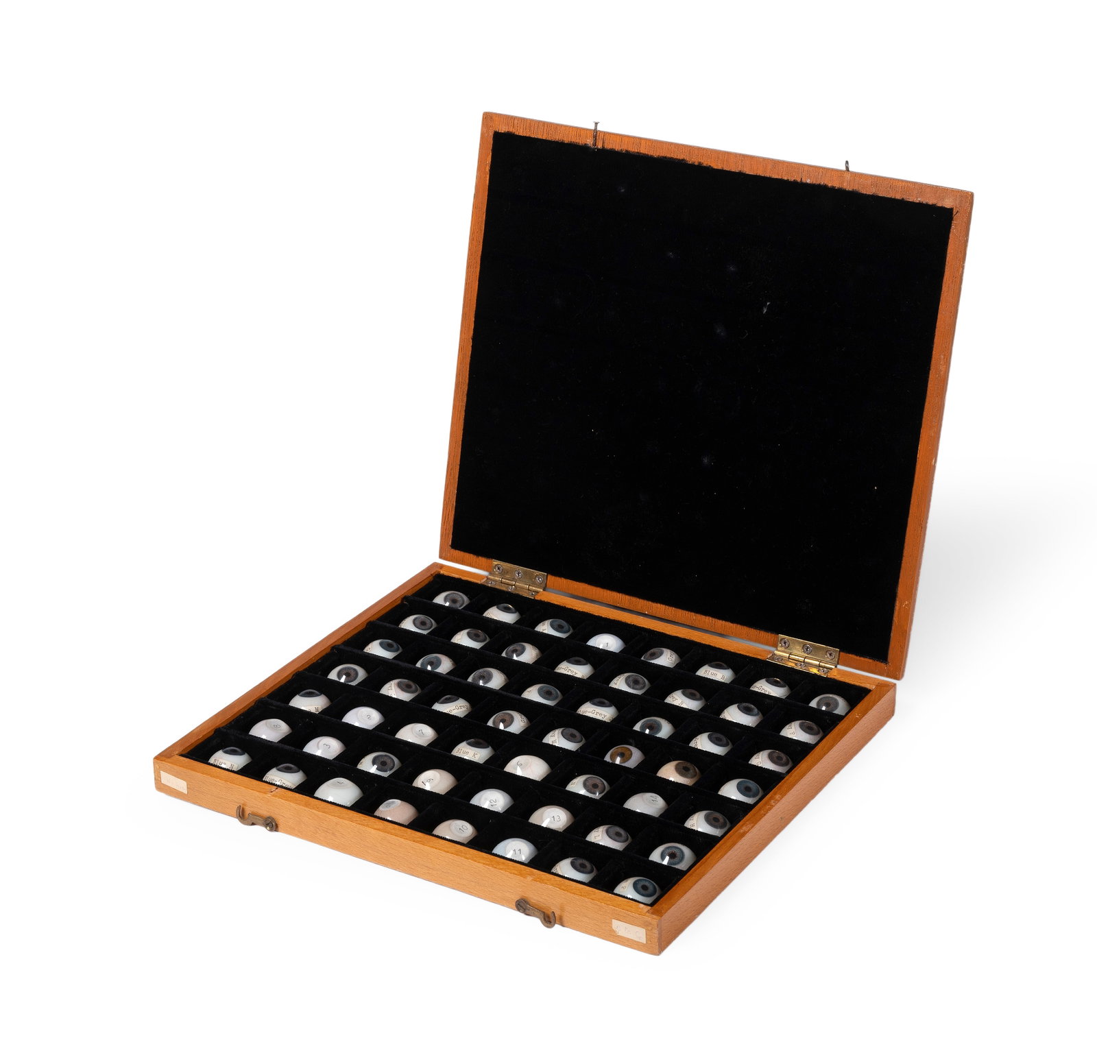 A CASED SET OF FIFTY-SIX OPTICIAN'S PROSTHETIC EYES, LATE 19TH OR EARLY 20TH CENTURY: A CASED SET OF FIFTY-SIX OPTICIAN'S PROSTHETIC EYES LATE 19TH OR EARLY 20TH CENTURY The irises in various named shades of blue and grey, most showing blood vessels and including fourteen without