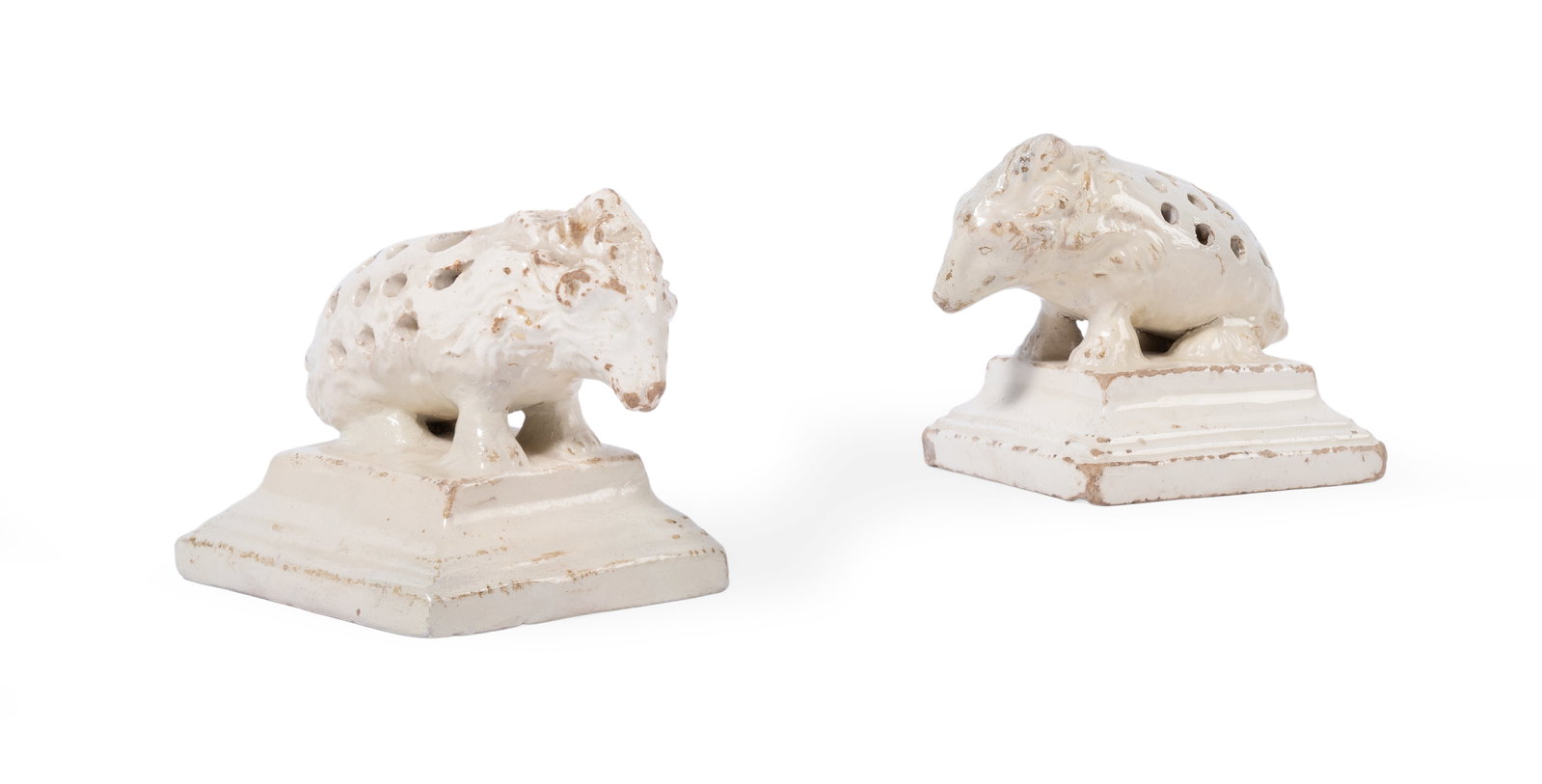A PAIR OF ENGLISH CREAM COLOURED POTTERY PORCUPINE TOOTHPICK HOLDERS, THIRD QUARTER 19TH CENTURY: A PAIR OF ENGLISH CREAM COLOURED POTTERY PORCUPINE TOOTHPICK HOLDERS ON PLINTH BASES THIRD QUARTER 19TH CENTURY 6.5cm high, base 8 x 6cm A matching example is held in the Dennis Severs