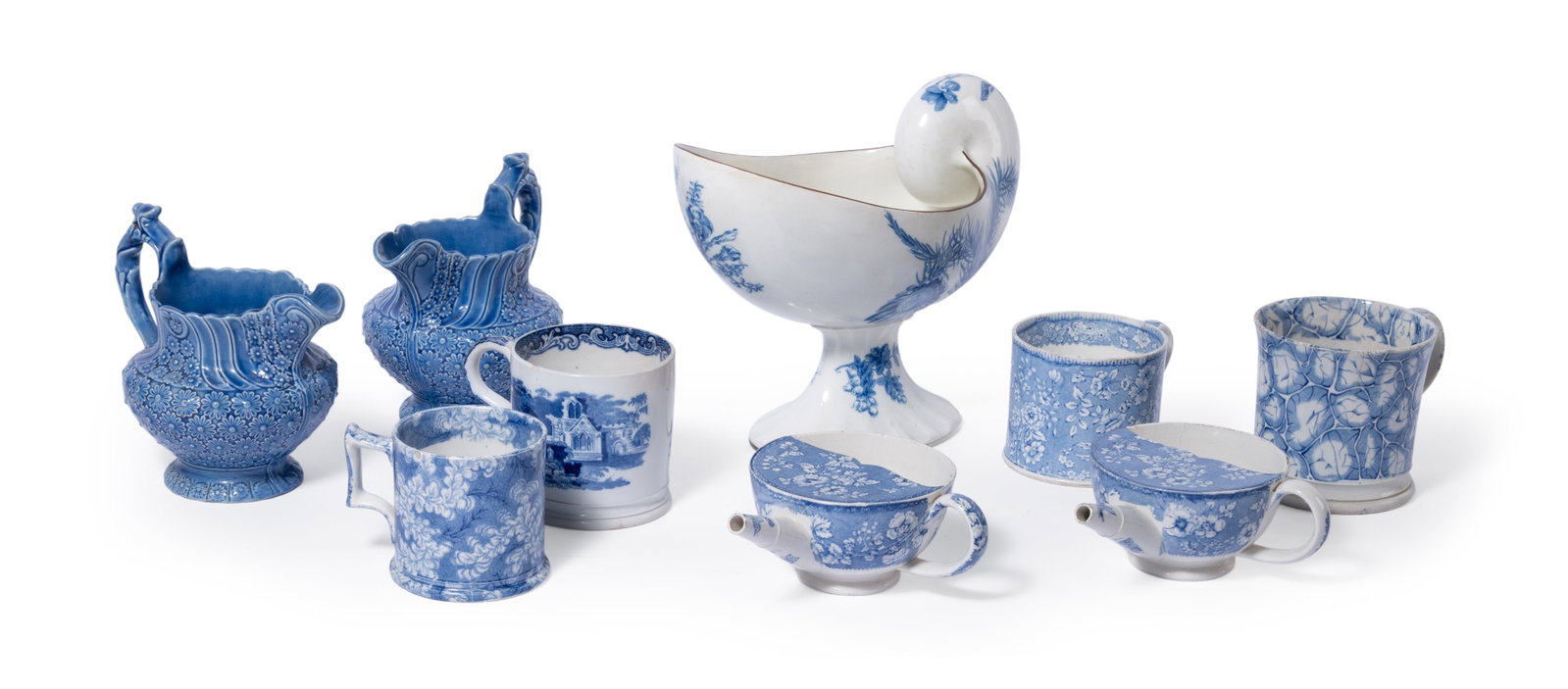 A LARGE WEDGWOOD NAUTILUS SHELL SHAPED PEDESTAL DISH, TOGETHER WITH FURTHER STAFFORDSHIRE WARES: A LARGE WEDGWOOD BLUE AND WHITE PEARLWARE NAUTILUS SHELL SHAPED PEDESTAL DISH FIRST HALF 19TH CENTURY Printed with flowers 21.5cm high, 26.5cm long Together with a selection of other blue and white
