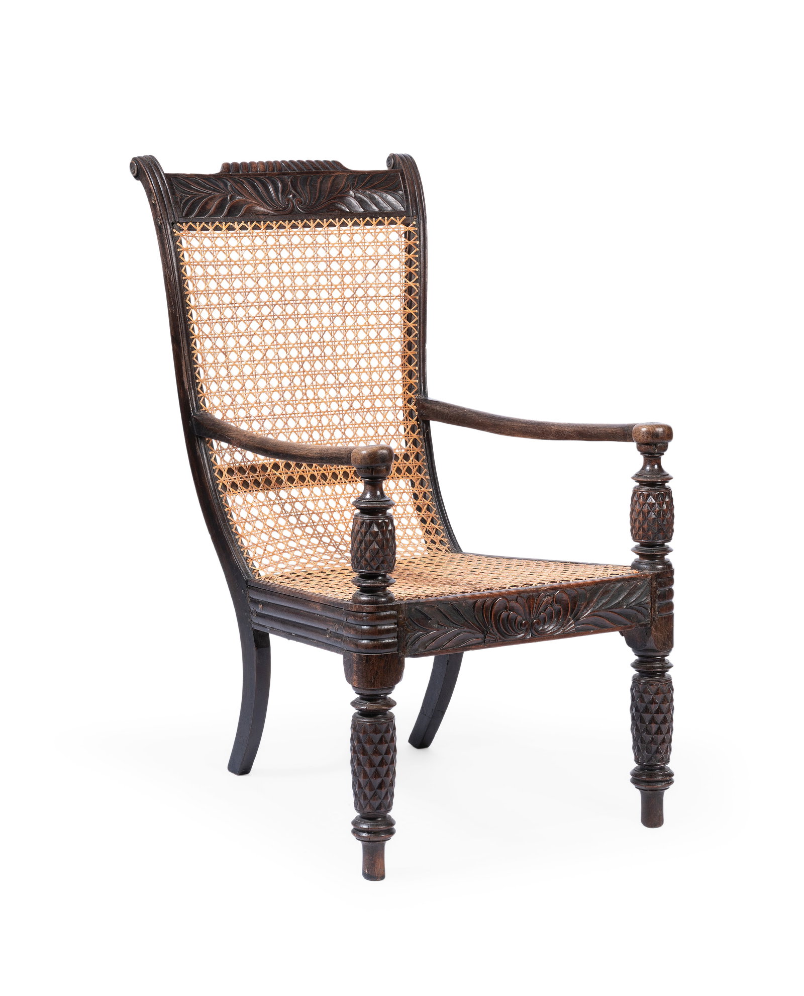 A TEAK ARMCHAIR, ANGLO-INDIAN, LATE 19TH CENTURY: A TEAK ARMCHAIR ANGLO-INDIAN, LATE 19TH CENTURY The foliate carved frame with replacement arms 105cm high, 65cm wide, 77cm deep Condition Report Disclaimer