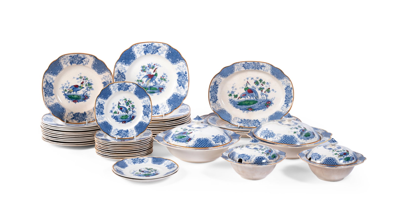 A STAFFORDSHIRE POTTERY 'CHELSEA PATTERN' PART DINNER SERVICE, LATE 19TH CENTURY: A STAFFORDSHIRE POTTERY 'CHELSEA PATTERN'BLUE AND WHITE PRINTED PART DINNER SERVICE LATE 19TH CENTURY Overpainted in shades of green, red and yellow Including; twelve dinner plates, 24.5cm diameter,
